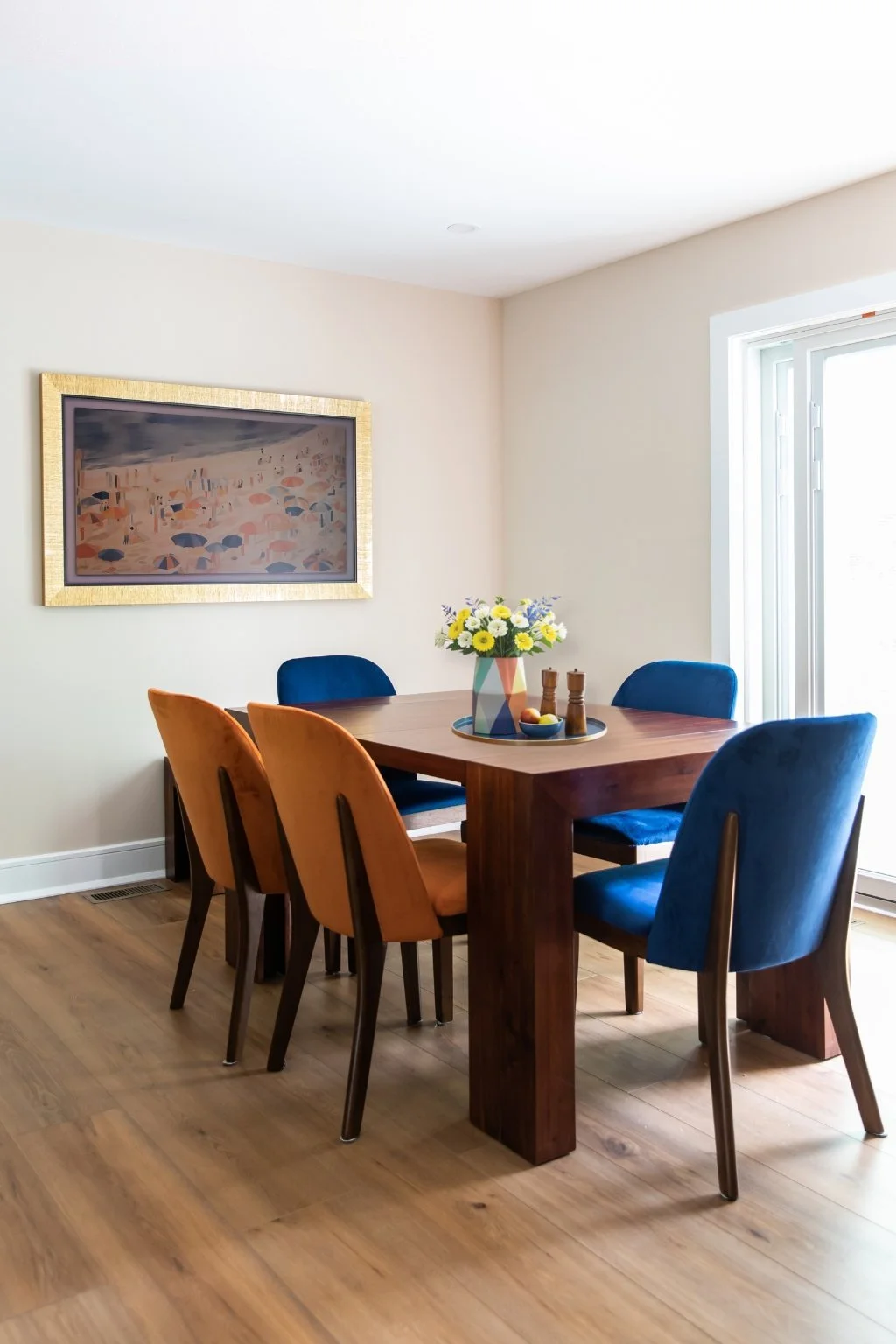 Eclectic dining room with walnut wood table and mixed velvet chairs in blue and rust designed by Caroline by Design in Montclair, NJ.