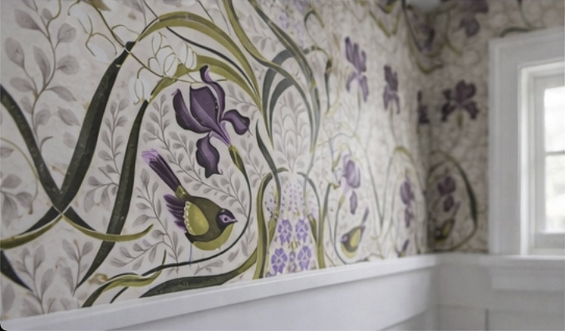 Botanical Art Nouveau wallpaper detail in a Montclair, NJ powder room designed by Caroline by Design featuring purple florals and brass accents.