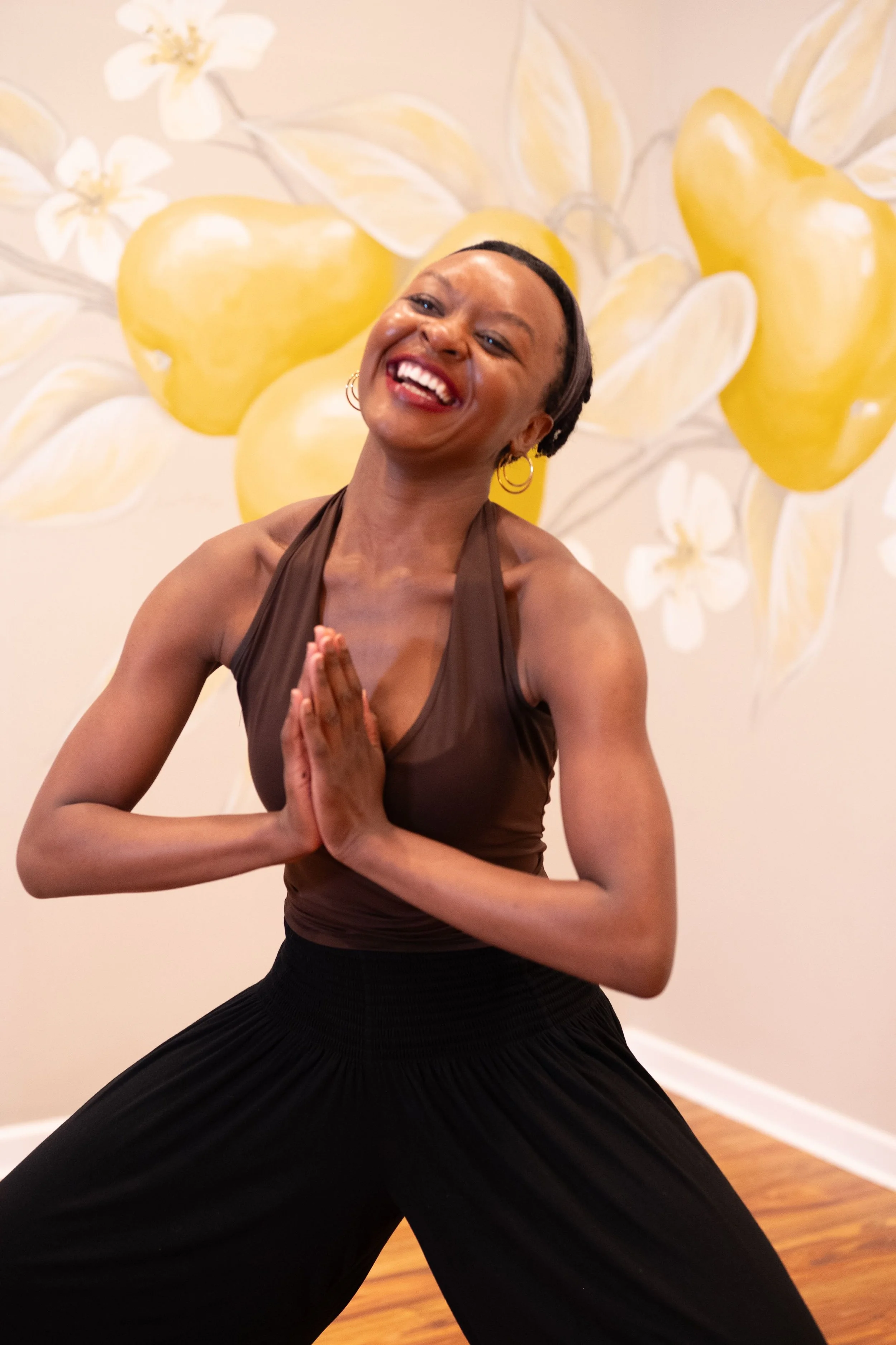 Woman smiling with hands together doing yoga