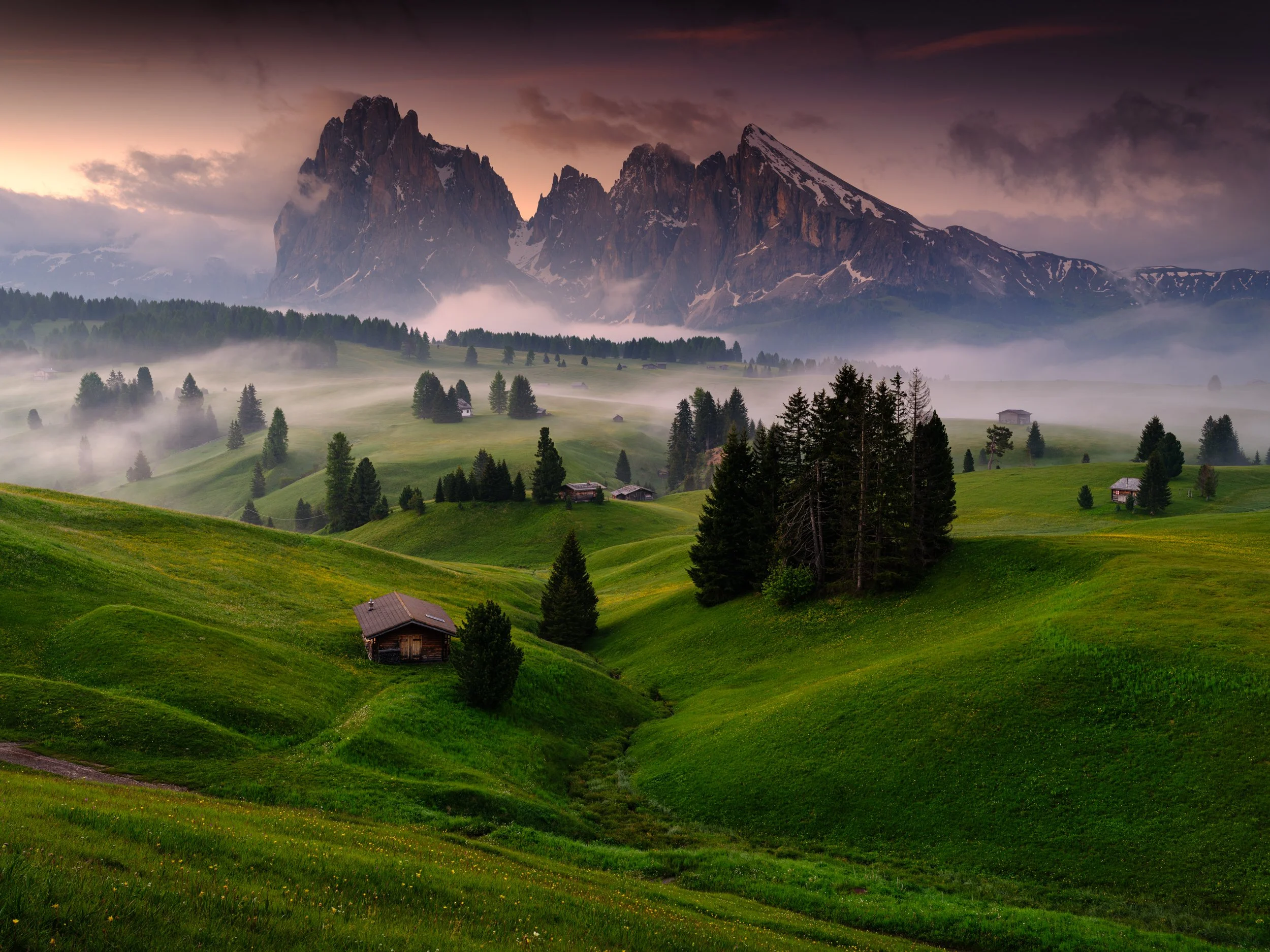 Sassolungo catching the morning light and mist.