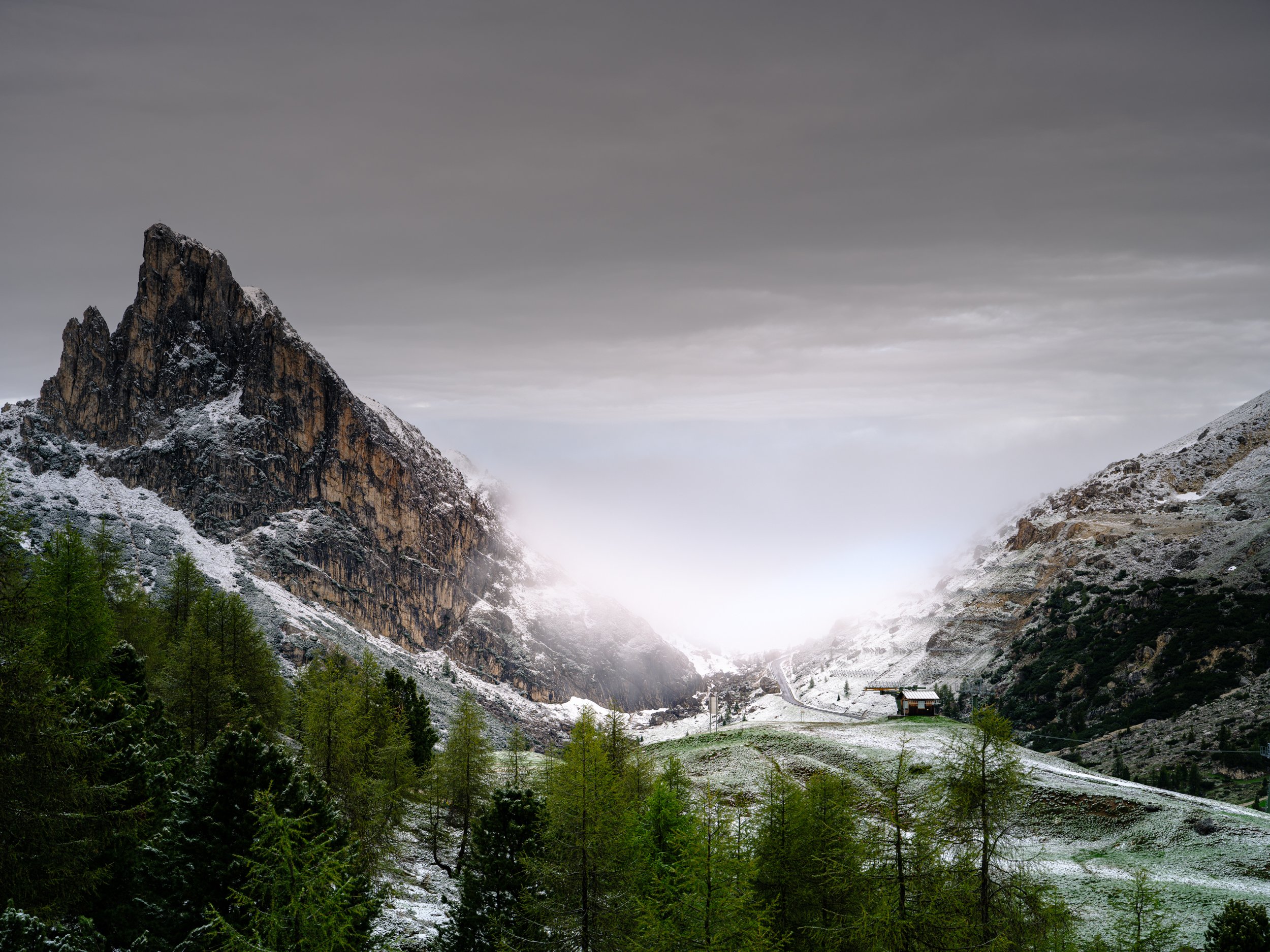 Sass de Stria (on the left) and Falzarego Pass (center) after overnight snowfall in June.