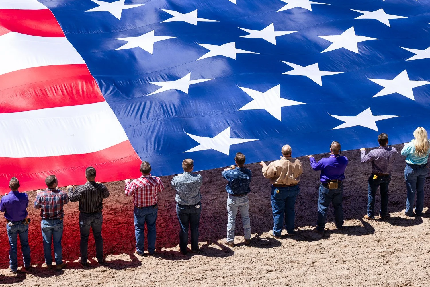 Cheyenne Frontier Days salutes the Military with Military Monday, volunteers hold an arena-sized US flag during the National Anthem in Cheyenne, Wyoming.