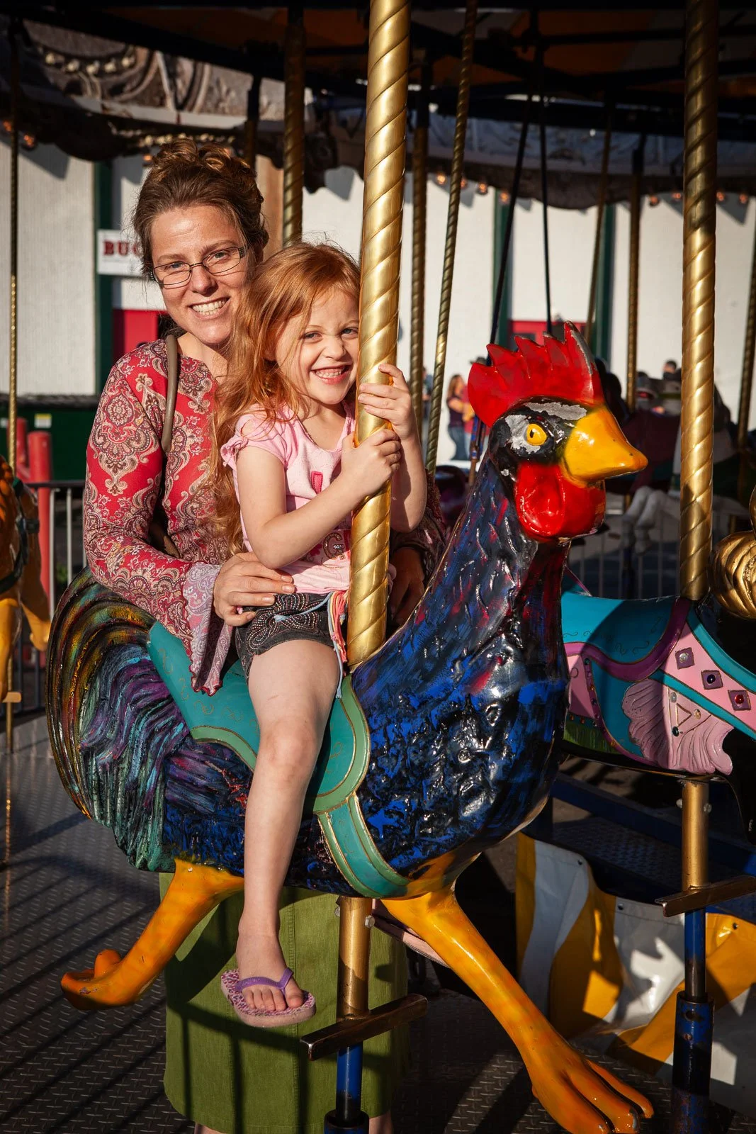 A mother and daughter enjoy the carousel wheel at the carnival at Cheyenne Frontier Days.