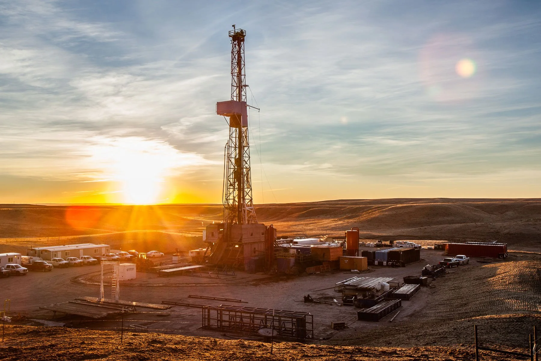 Oil and gas drilling rig at sunset near the Wyoming and Colorado state line.