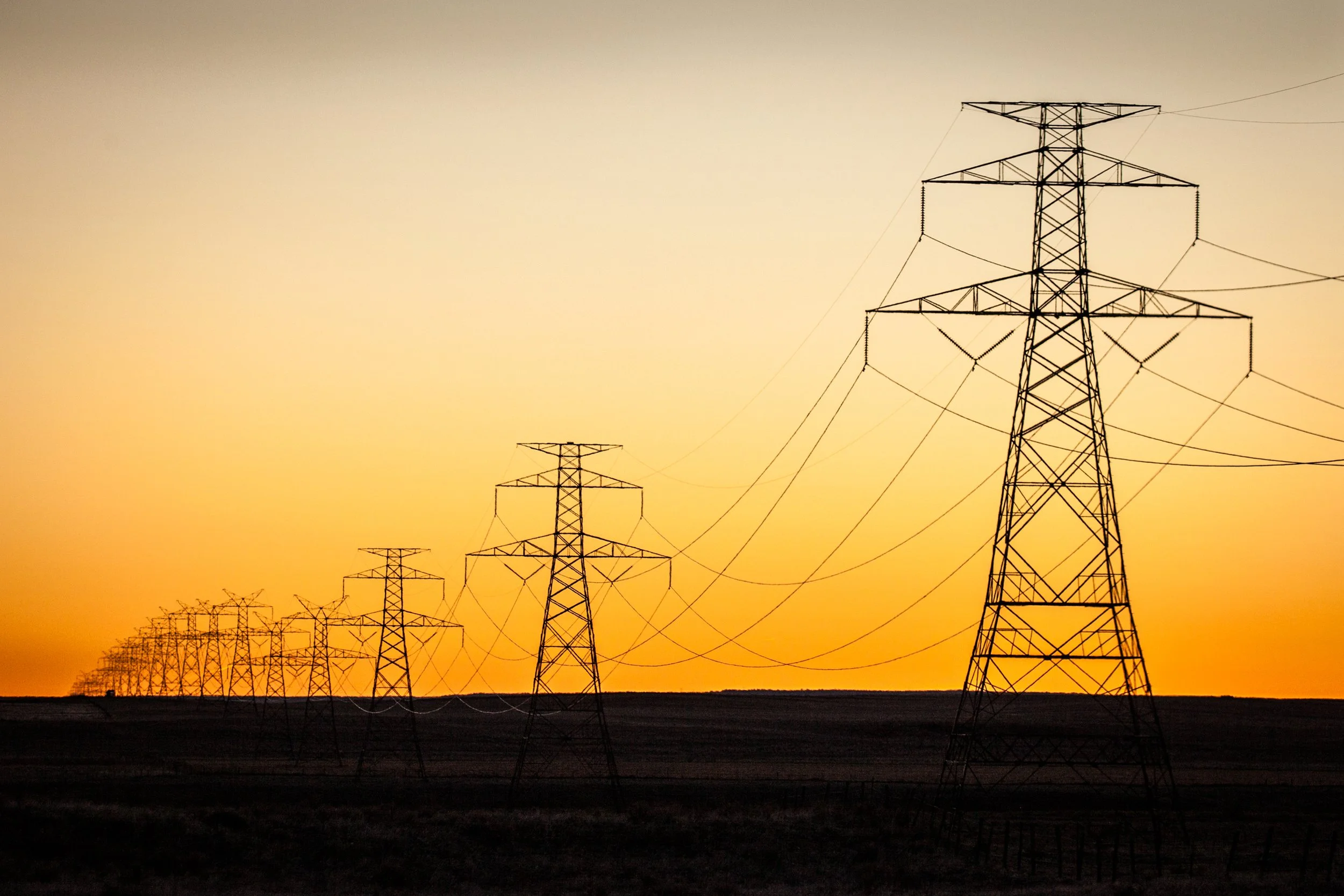 Transmission lines in southeastern Wyoming during sunrise.