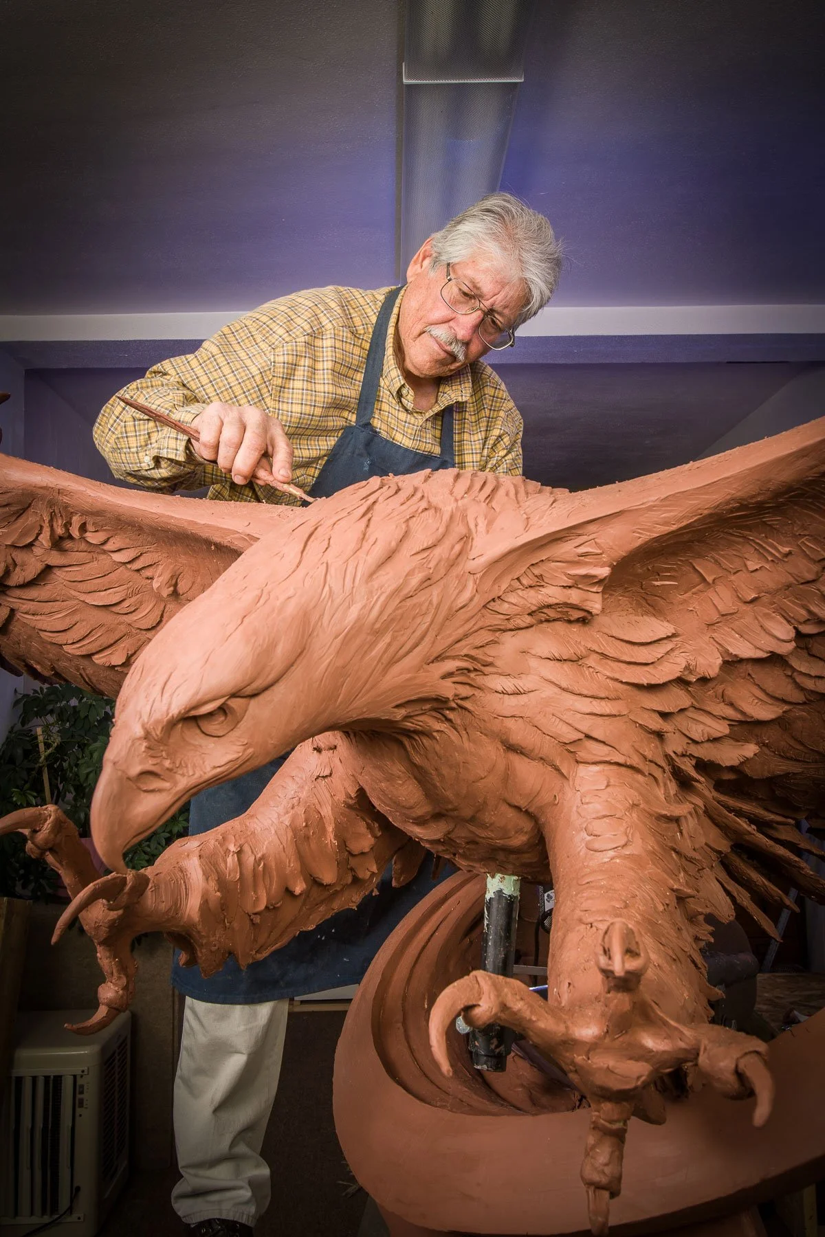 Marketing portrait for LCCC, including a sculpture creating a bronze eagle in Laramie, Wyoming.