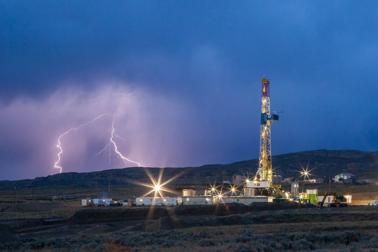 Lightning strikes near a drilling rig in the Big Sand Draw near Riverton, Wyoming. Industrial photography including the oil and gas industry in Casper, Wyoming.