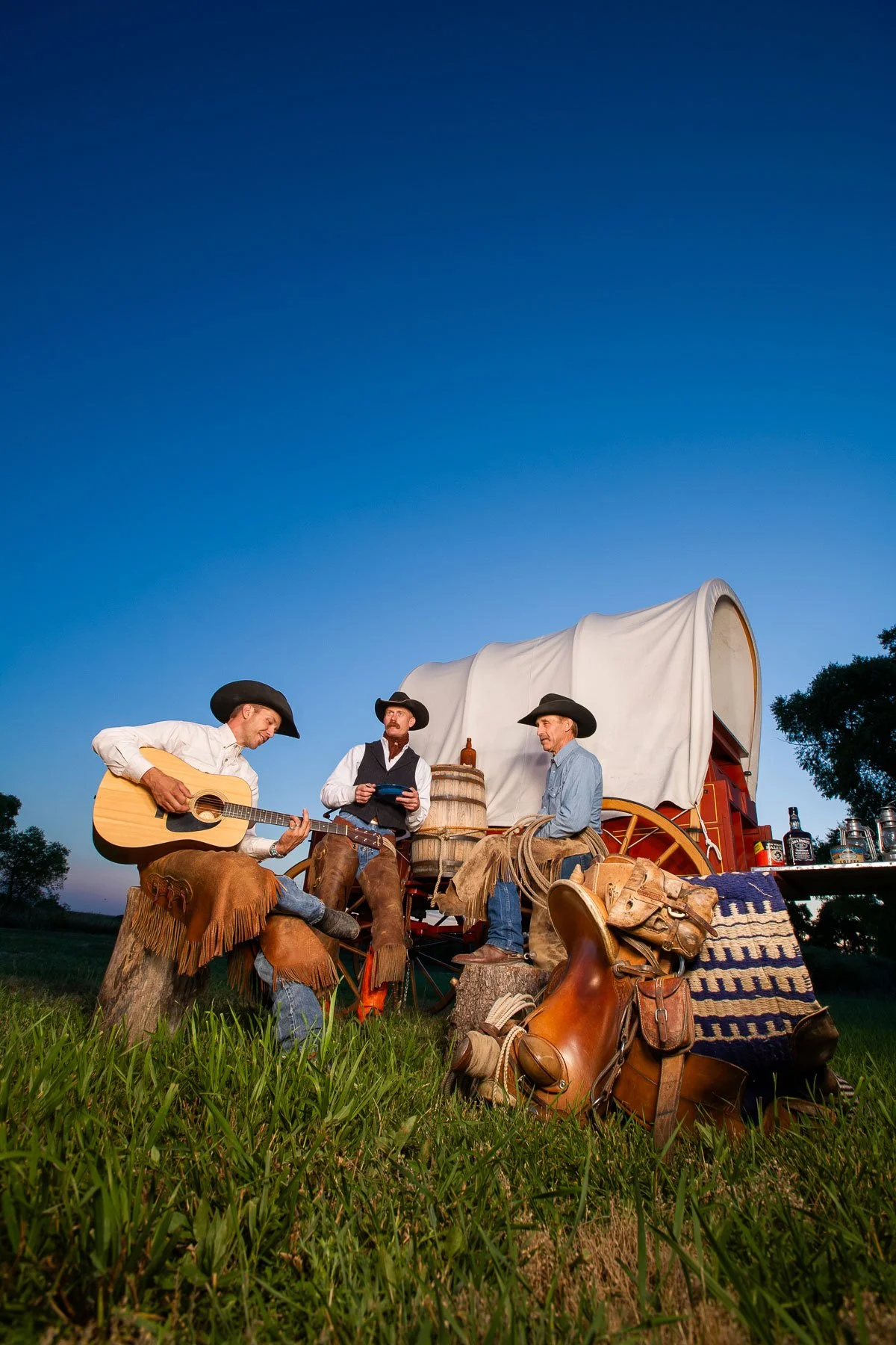 Cowboys at a chuck wagon during sunrise for marketing for a music festival in Cheyenne, Wyoming.