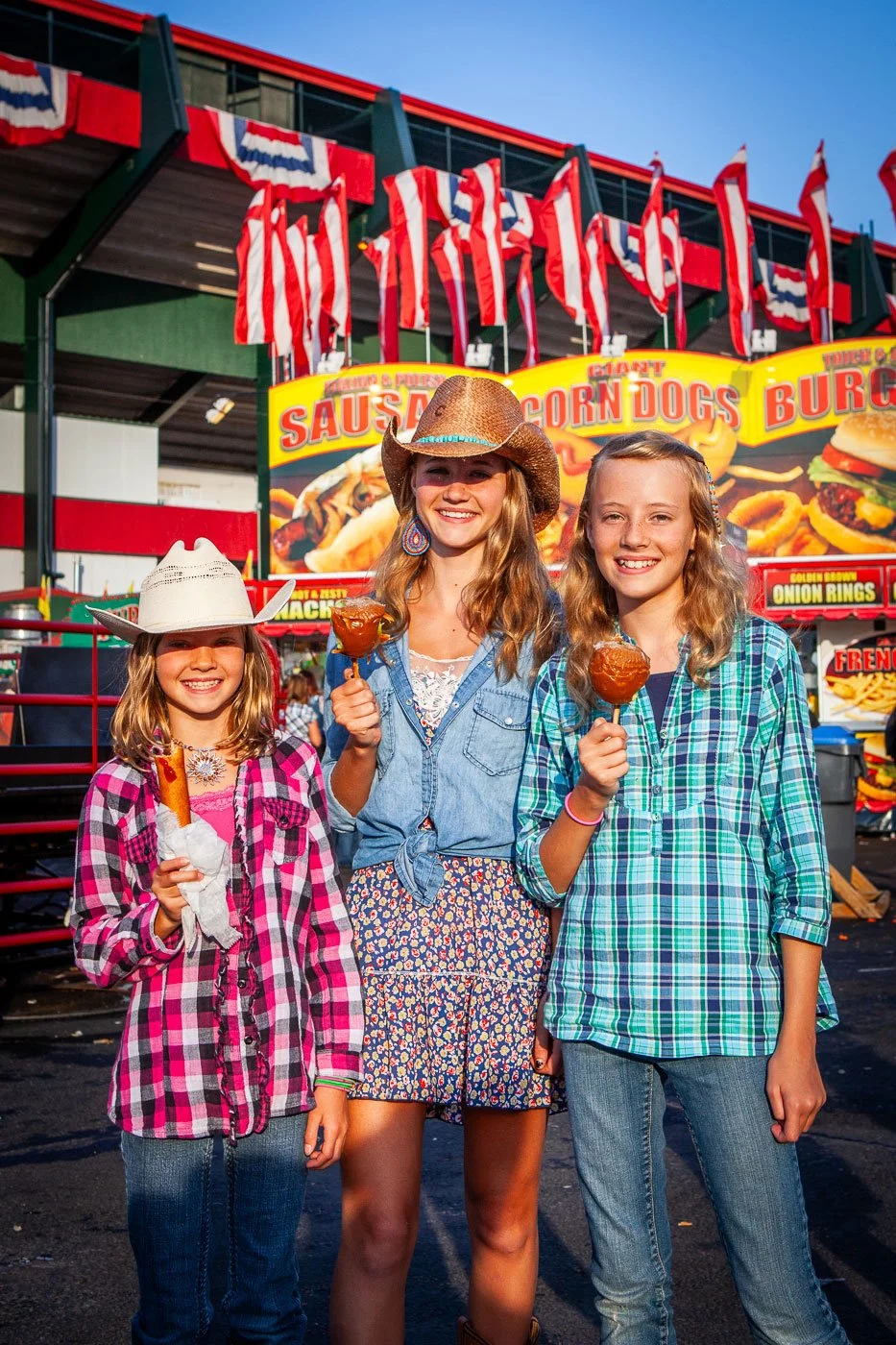 Girls enjoy carnival food at the Cheyenne Frontier Days Rodeo Carnival and Midway in Cheyenne, Wyoming.