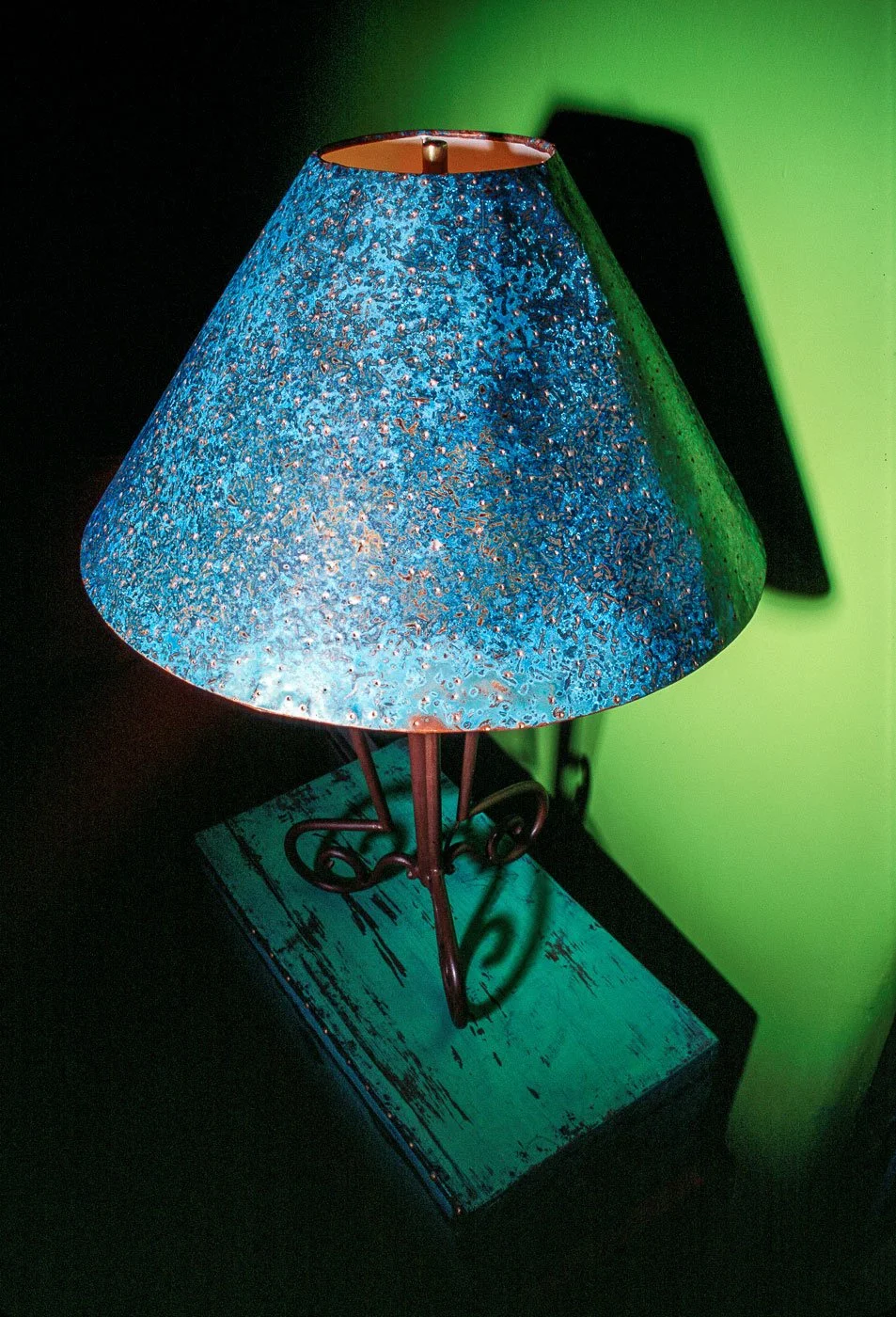 Product photography at a rental home in Toas, New Mexico. Blue shade with lamp on green background product photography