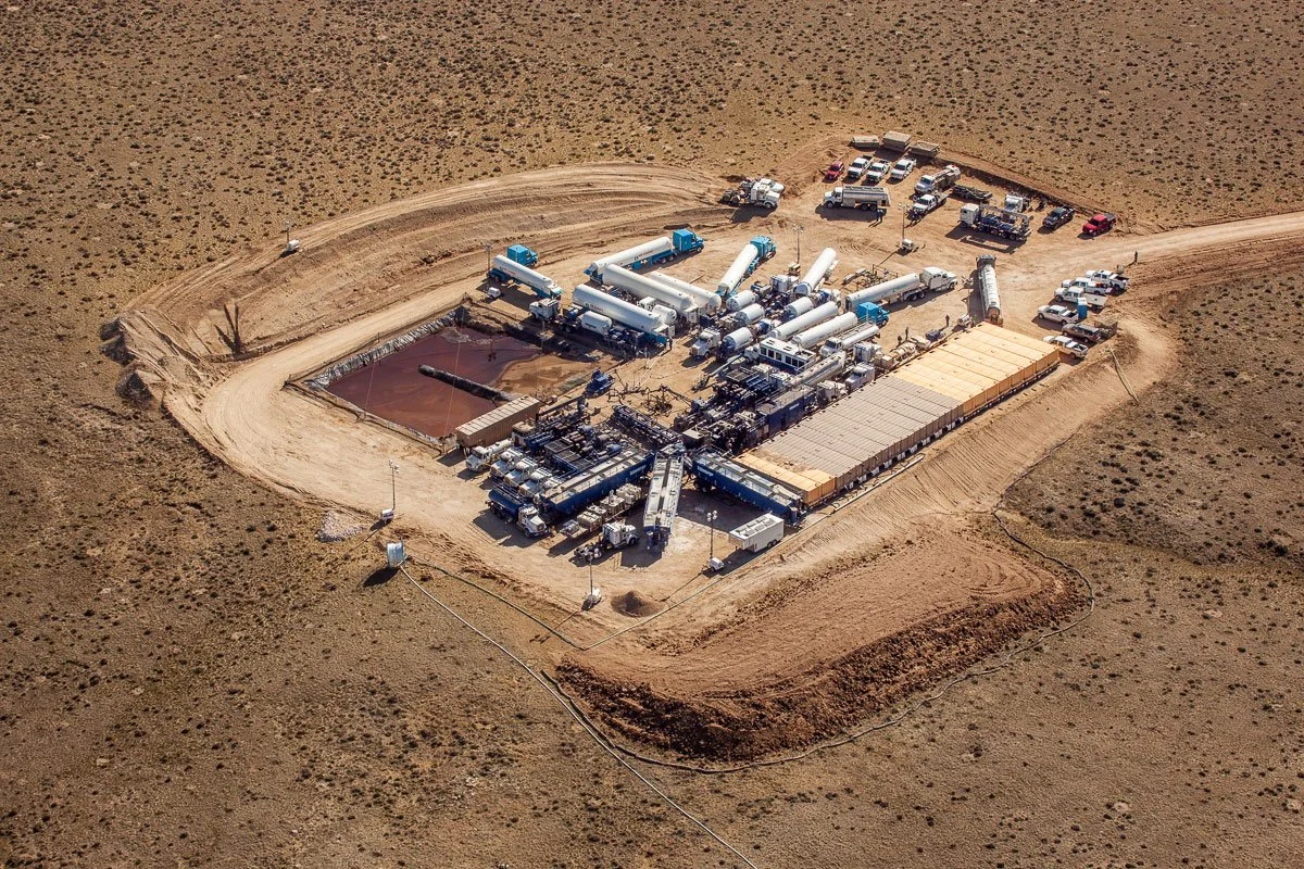 Aerial photography of a well site and well being fracked in Central Wyoming.