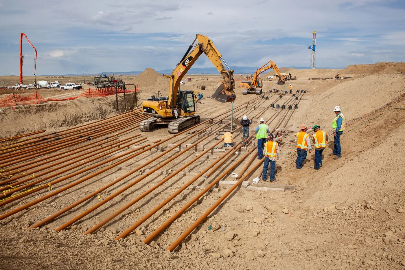 Pipeline construction near an oil and gas drilling rig.