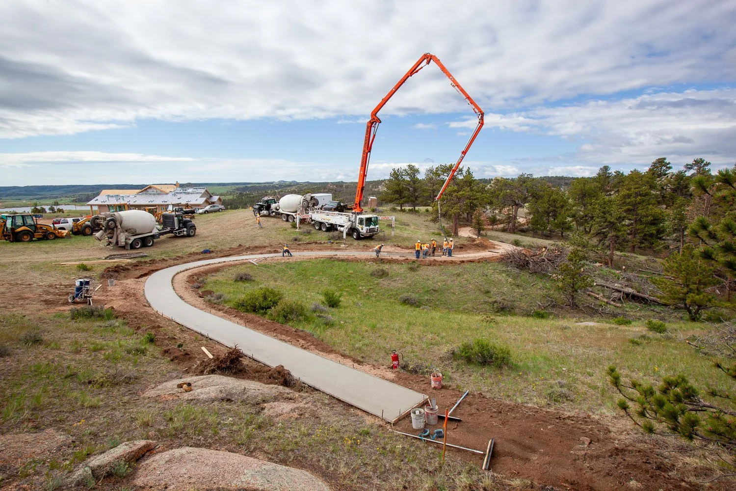 Walking path construction with a concrete pump truck and cement trucks in Cheyenne, Wyoming.
