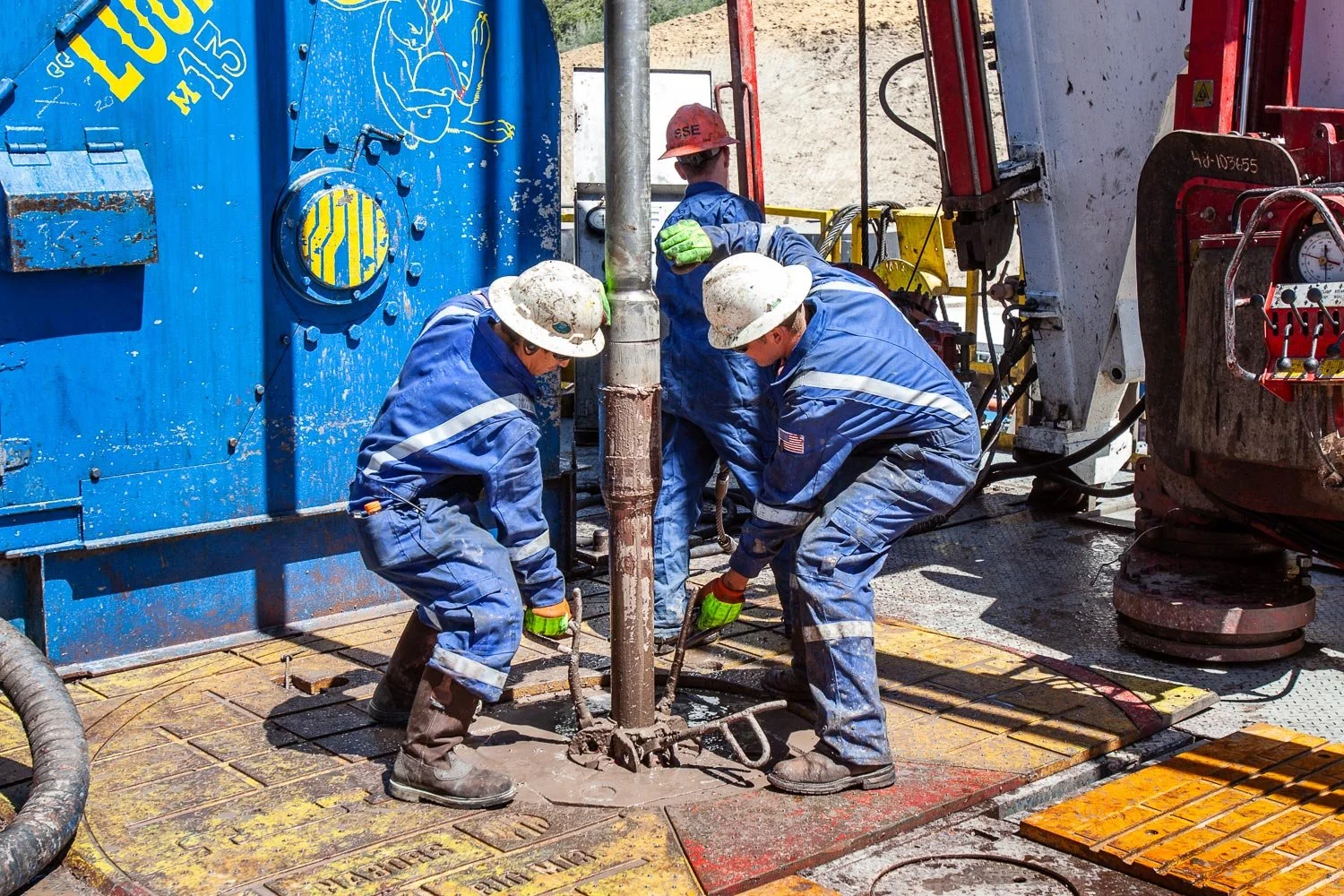 Oil and gas field workers on a drilling rig near Parachute, Colorado.