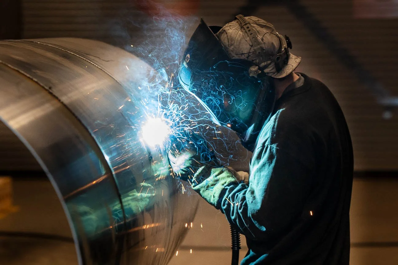 Construction and Manufacturing Photography for marketing and editorial use, including a welder welding a cylinder for the oil and gas industry.