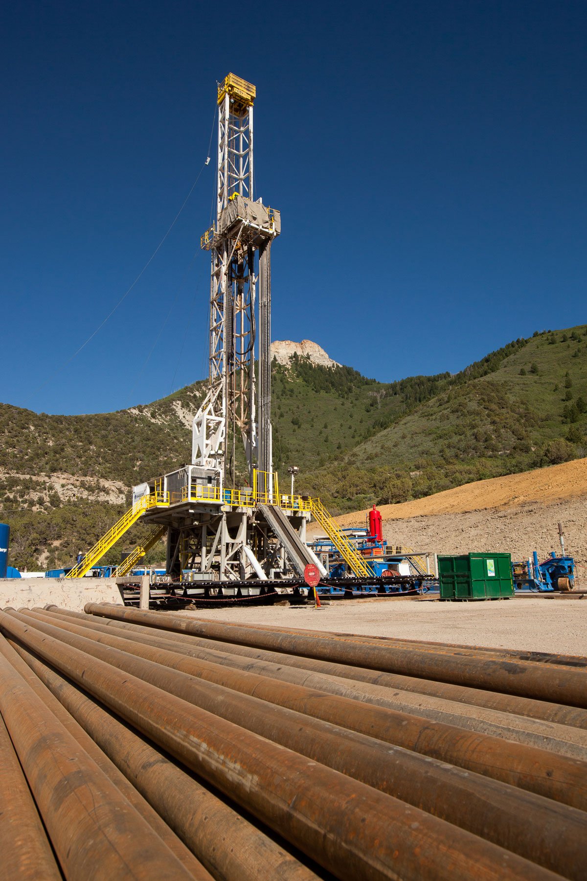 An oil drilling rig near Parachute, Colorado, with mountains in the background.