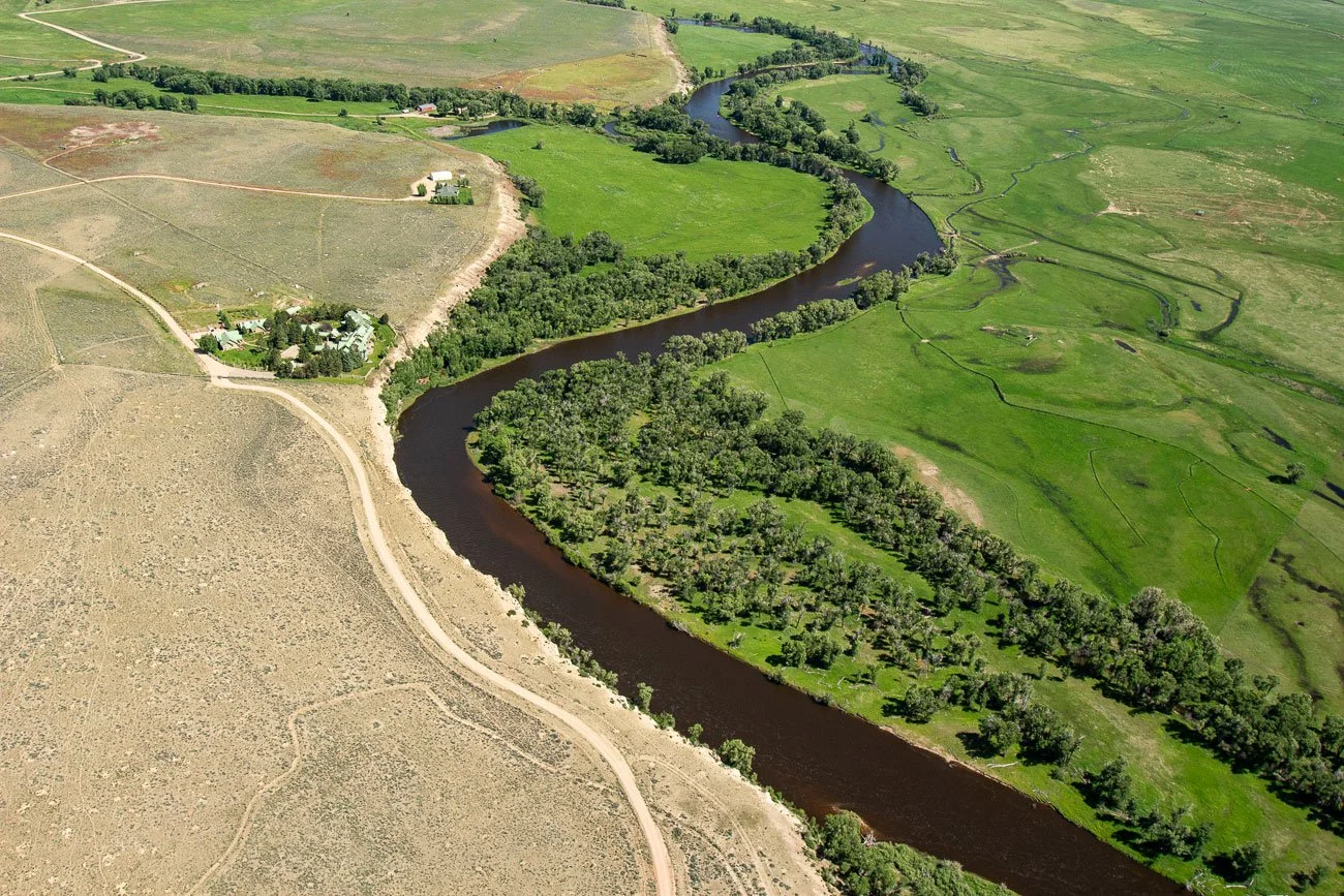 Aerial photography of the Riverbend Lodge in Saratoga, Wyoming. The North Platte River flows right next to the lodge.