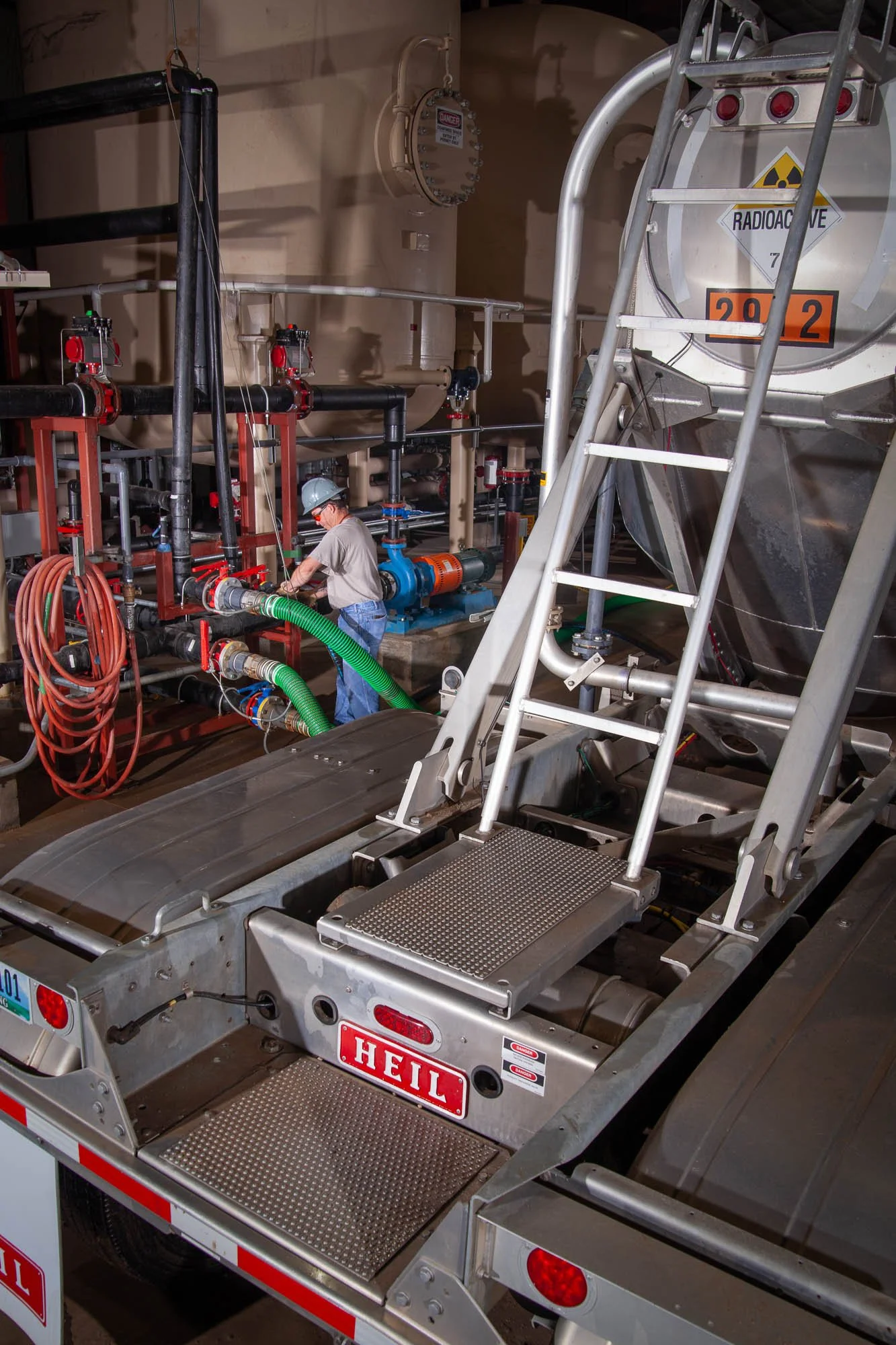 Uranium mining photography with a worker unloading a tanker in Central Wyoming.