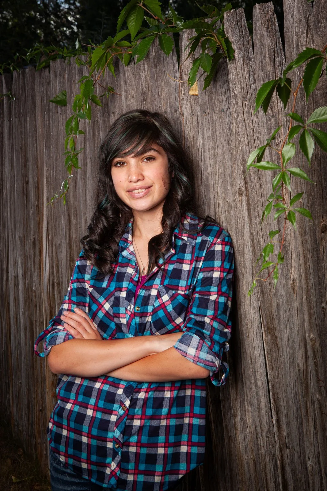 Senior portraits with a wood fence as background in Cheyenne, Wyoming.