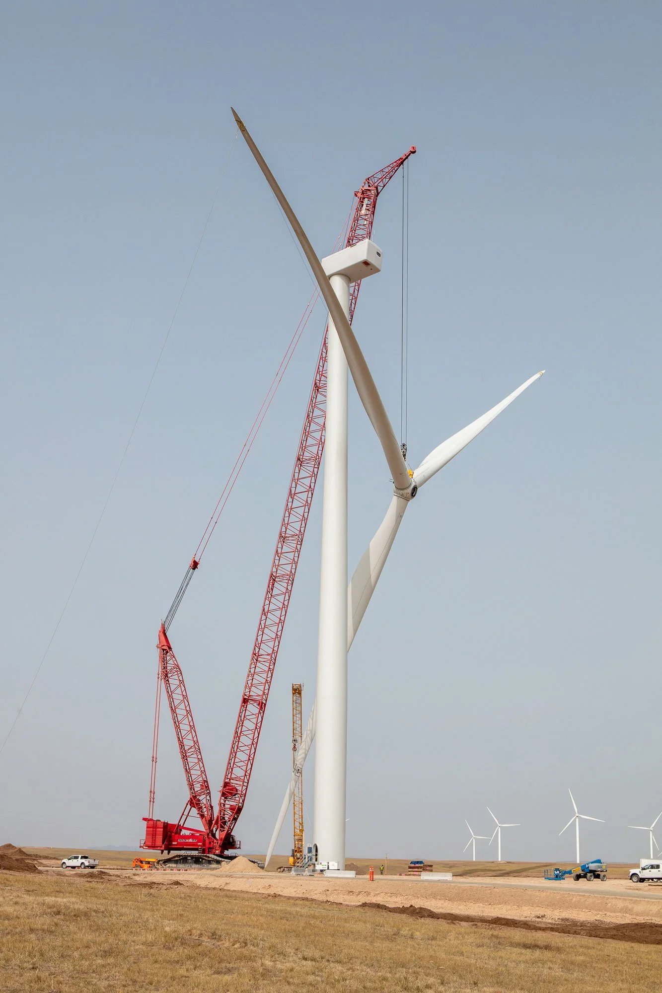 Crane work installing blades and turbine head on a windmill at the Black Hills Corporation Corriedale Wind Farm near Cheyenne, Wyoming.