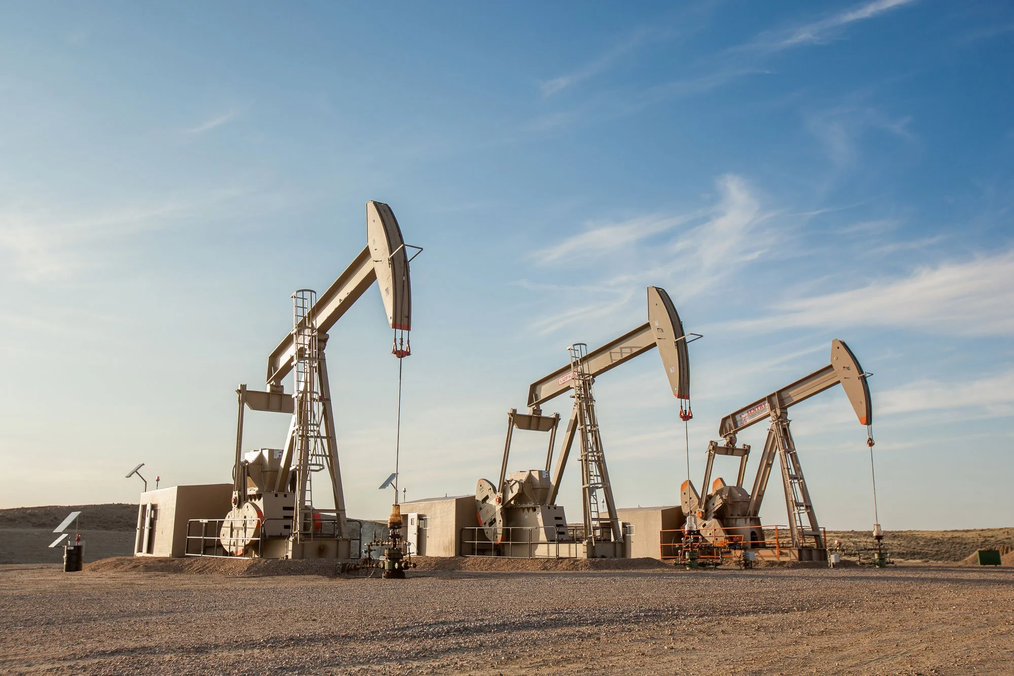 Three pump jacks are producing oil in Central Wyoming near Douglas.