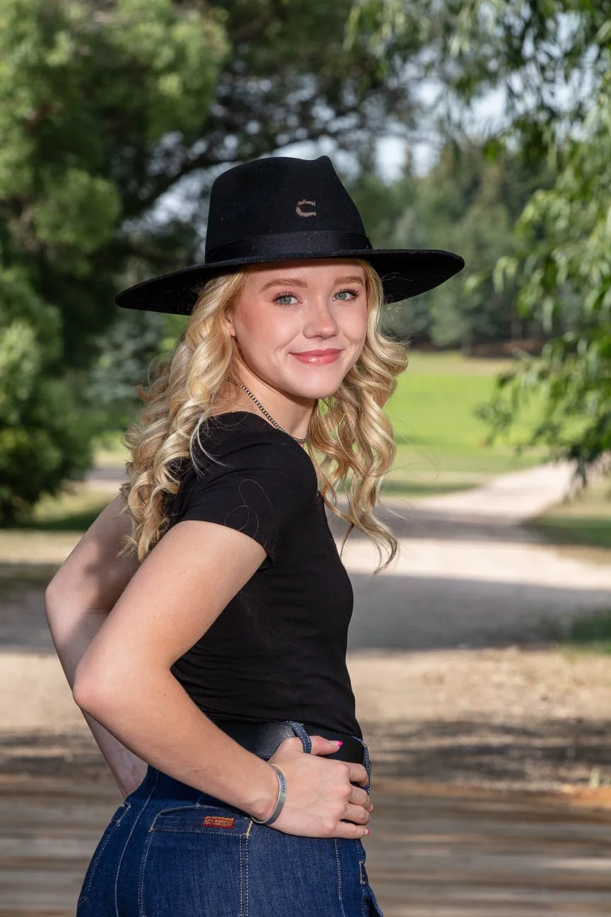 Senior portrait on location including a high school senior with cowboy hat.
