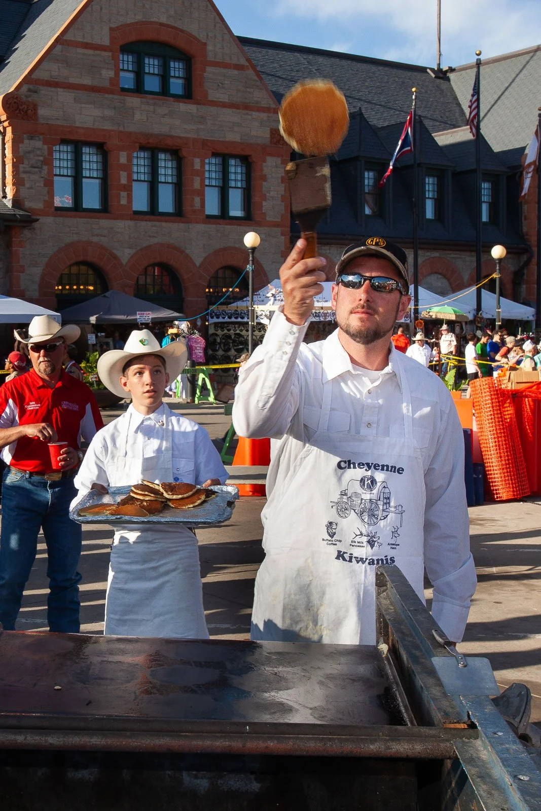 Pancakes fly at the Cheyenne Frontier Days Pancake Breakfast in downtown Cheyenne, Wyoming.
