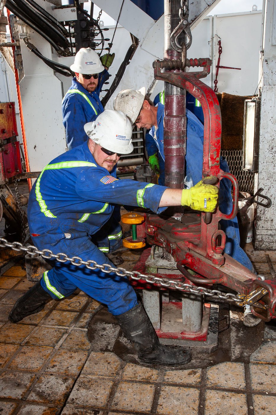 Oil rig worker working on a drilling rig at Lysite, Wyoming.