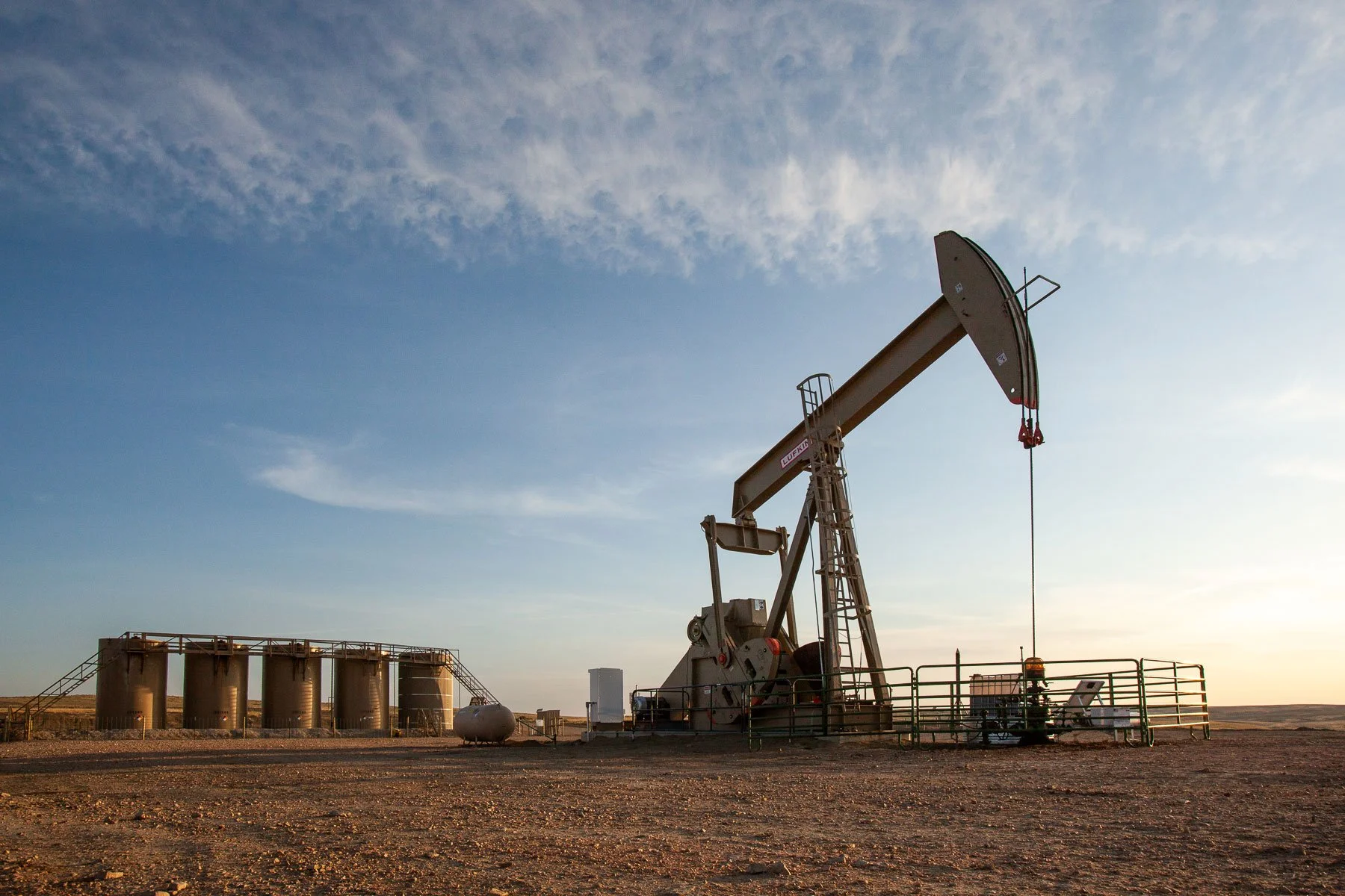 Pumpjack and oil tanks at sunset, located south of Gillette, Wyoming.