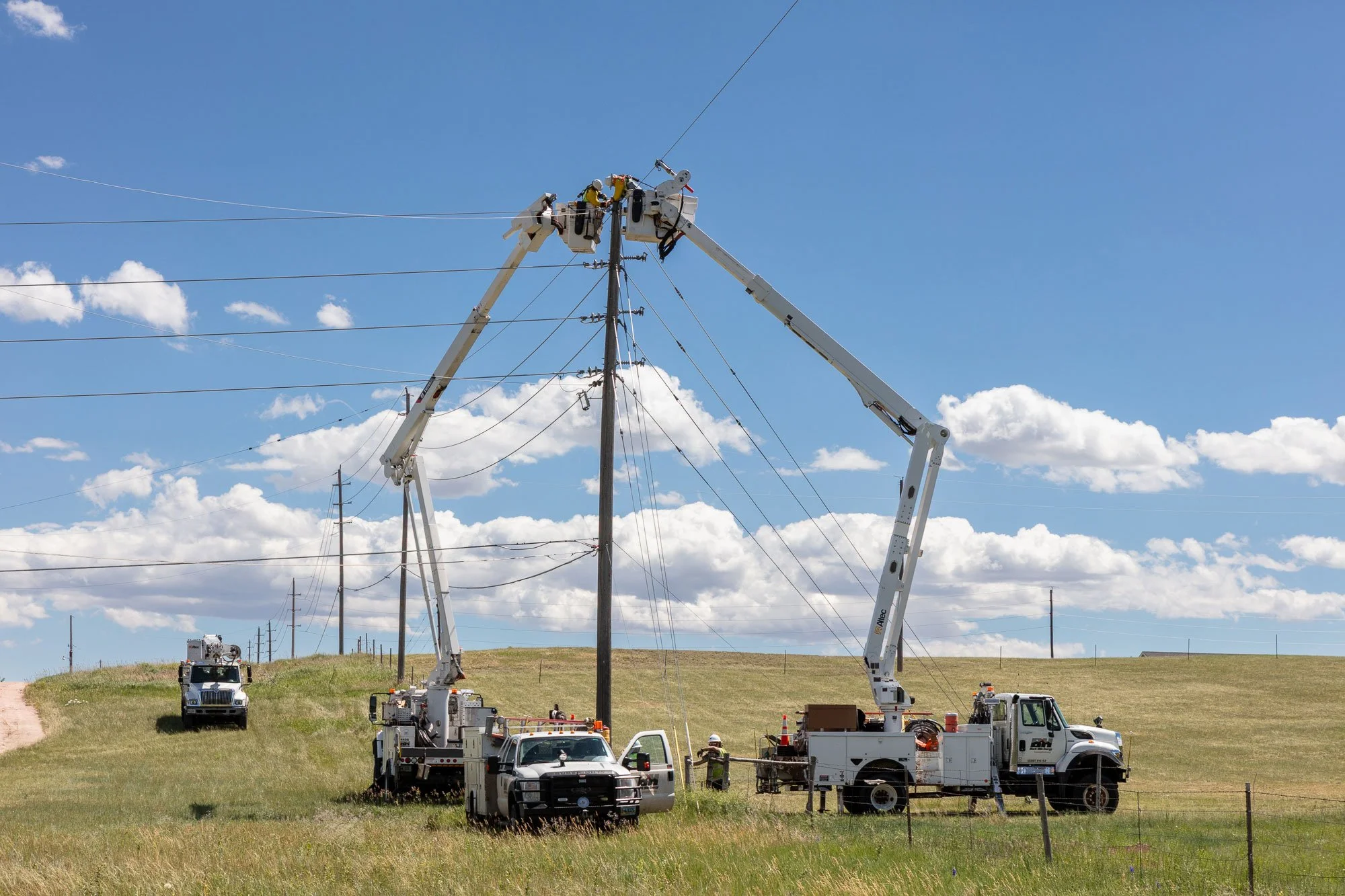 A lineman crew pulls new line to a new power pole in Cheyenne, Wyoming.
