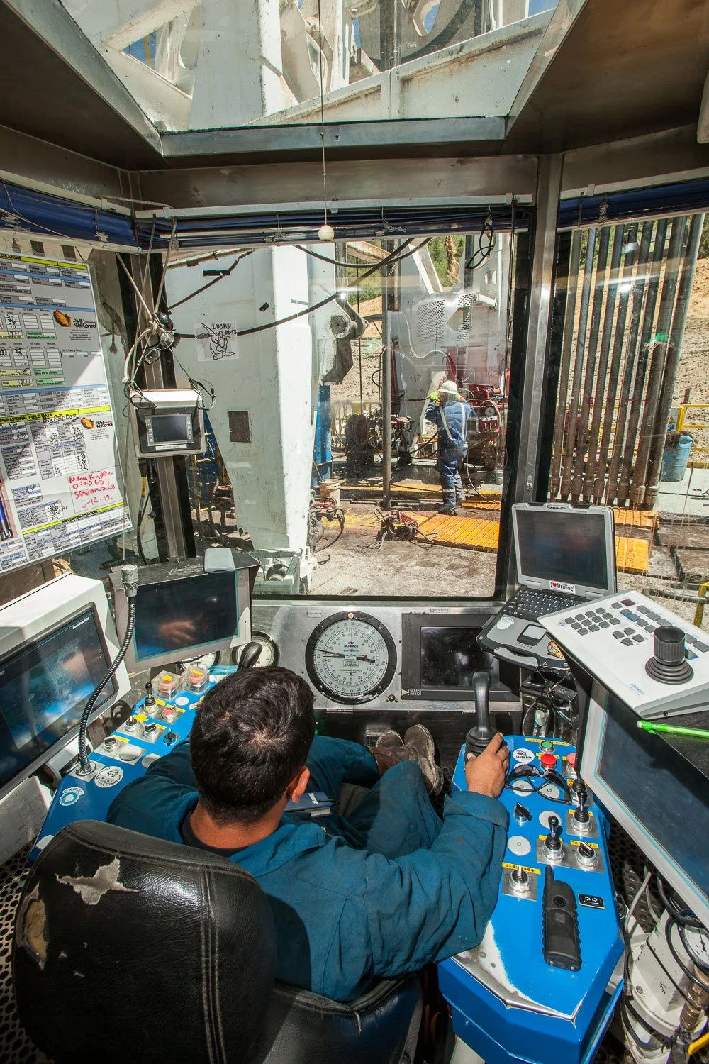 Drilling rig operator on a drilling rig near Parachute, Colorado.