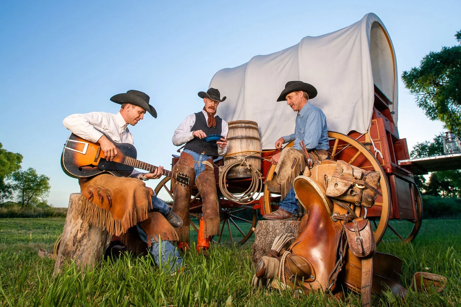 Cowboys at a chuck wagon during sunrise for marketing for a music festival in Cheyenne, Wyoming.