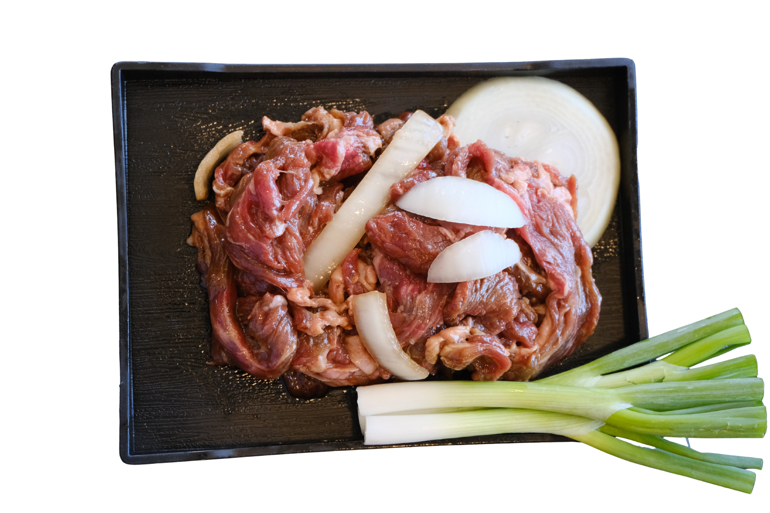 Raw sliced beef with sliced onions and green onions on a black tray
