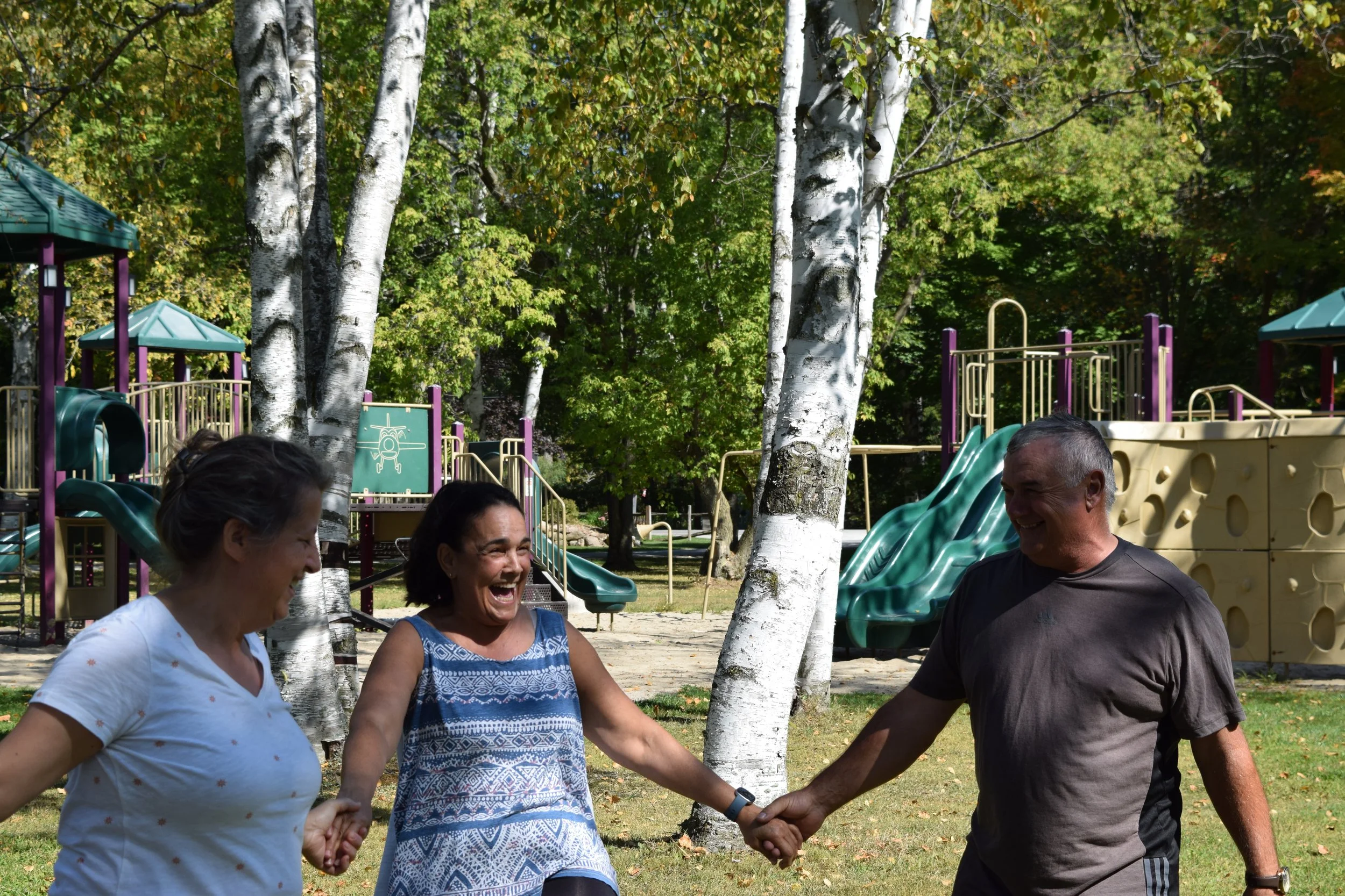Older adults (seniors) over the age of 60 having fun, enjoying a Jovia Life class that prioritizes joy and social connection. Designed to spark conversation and games with simple movements to develop muscle, flexibility and balance.