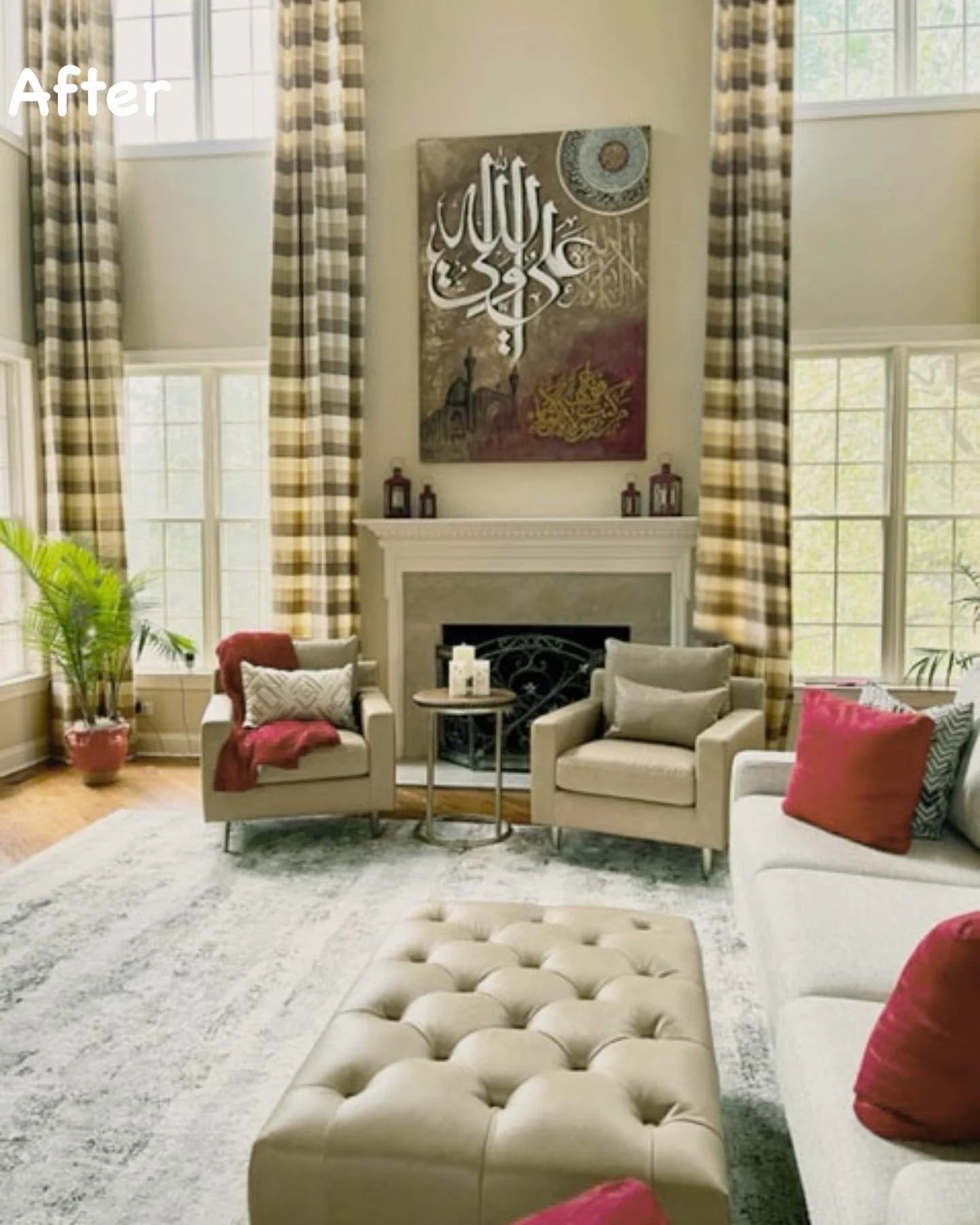 Living room with multiple armchairs, a fireplace, large windows with plaid curtains, and decorative items including lanterns on the mantle. There is a white tufted ottoman in the foreground and a patterned area rug.