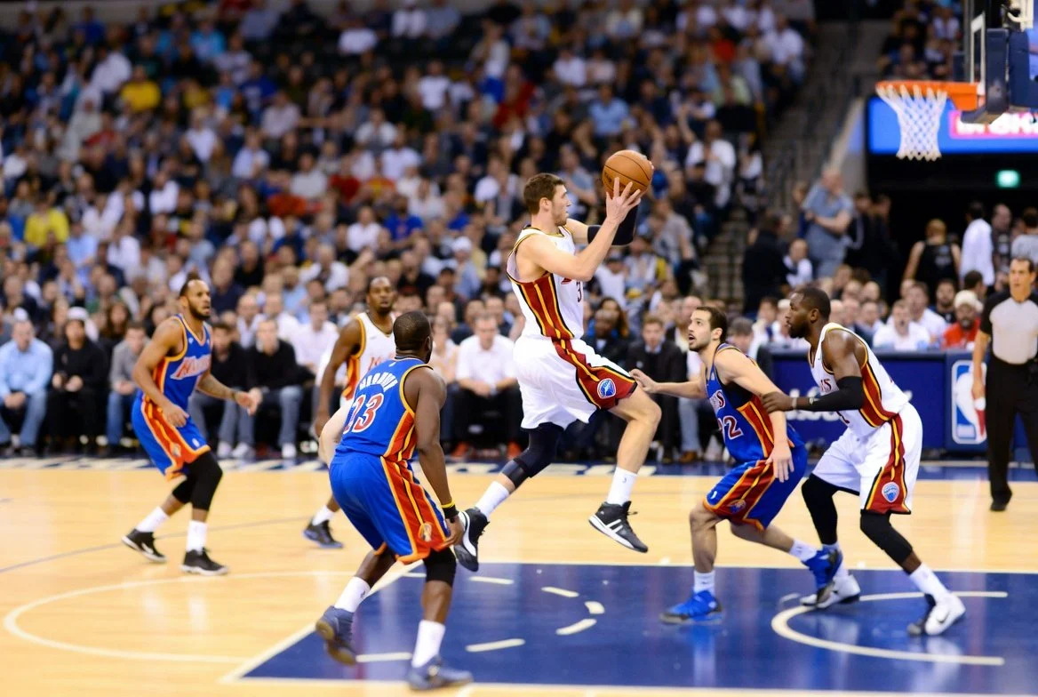 Basketball players competing in a live 5v5 game, showing real-game movement, spacing, and decision-making