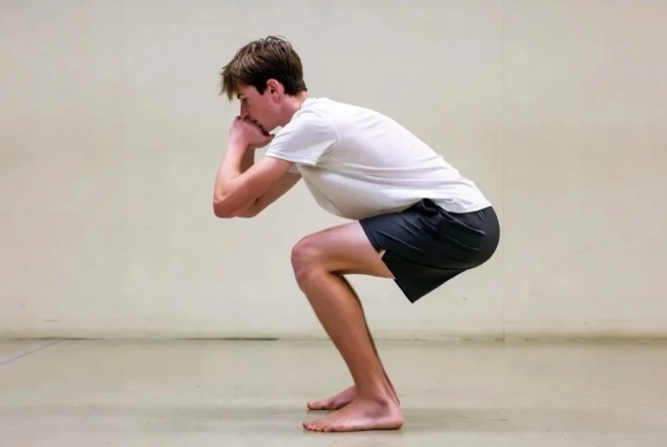 Youth basketball player performing a squat to assess movement quality and injury risk