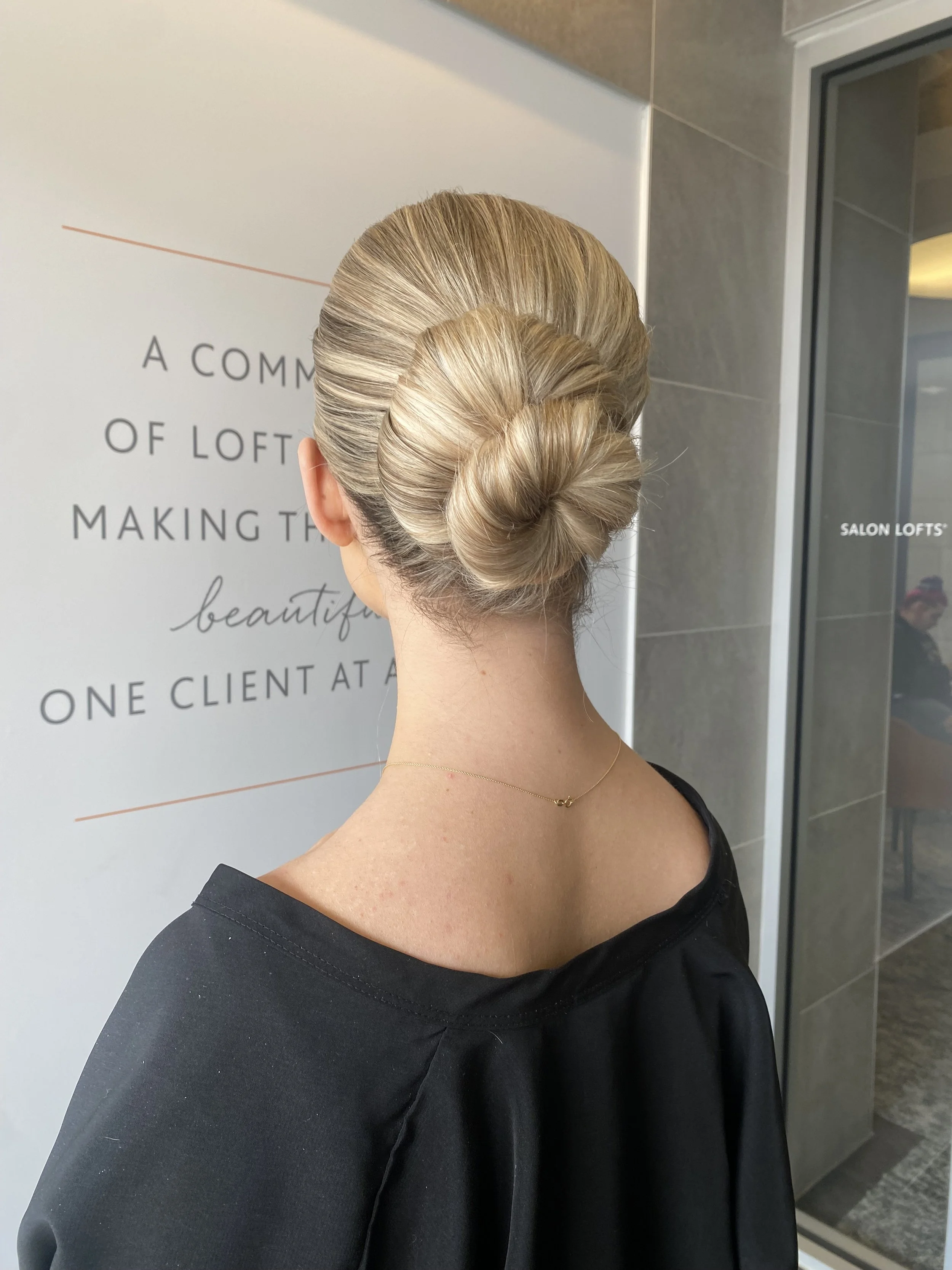 Sleek low bun updo for a wedding