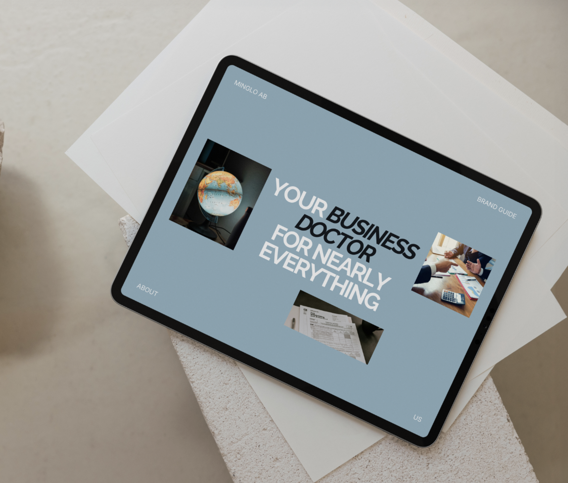 A tablet displaying a business guide titled 'Your Business Doctor for Nearly Everything' with images of a globe, meeting, and documents, placed on a white surface.