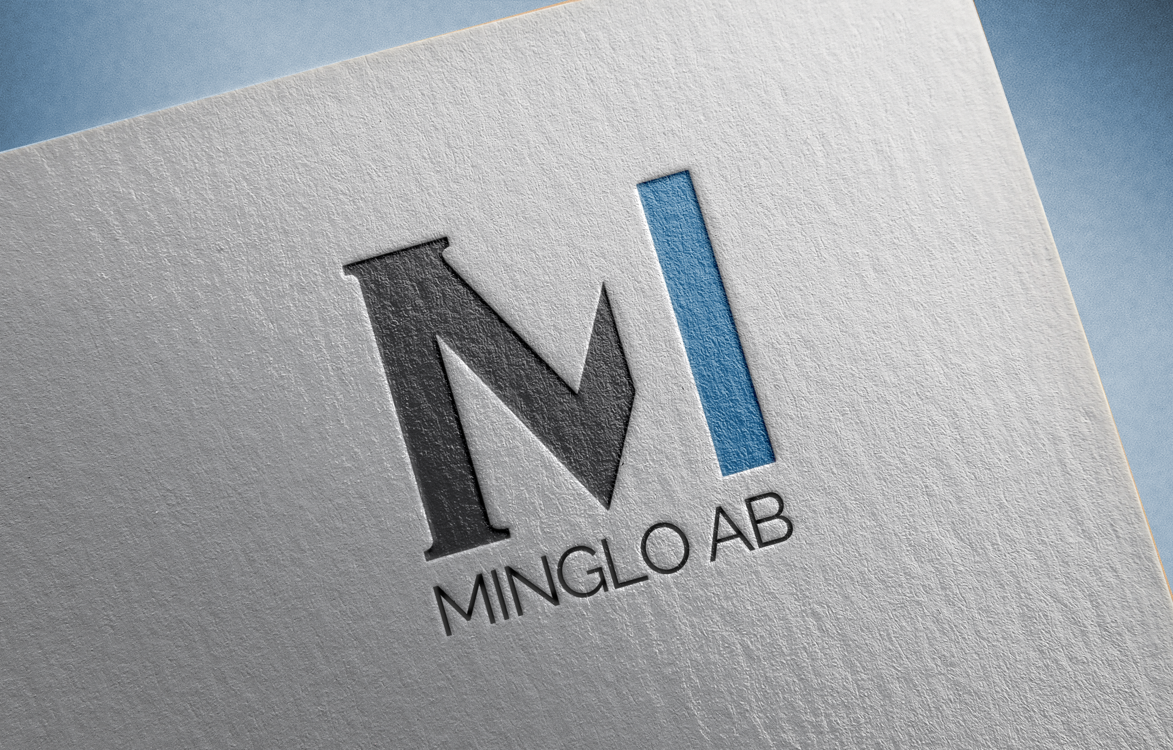 Close-up of a textured paper with a logo featuring a large letter 'M' with a blue vertical bar and the text 'MINGLO AB' underneath.