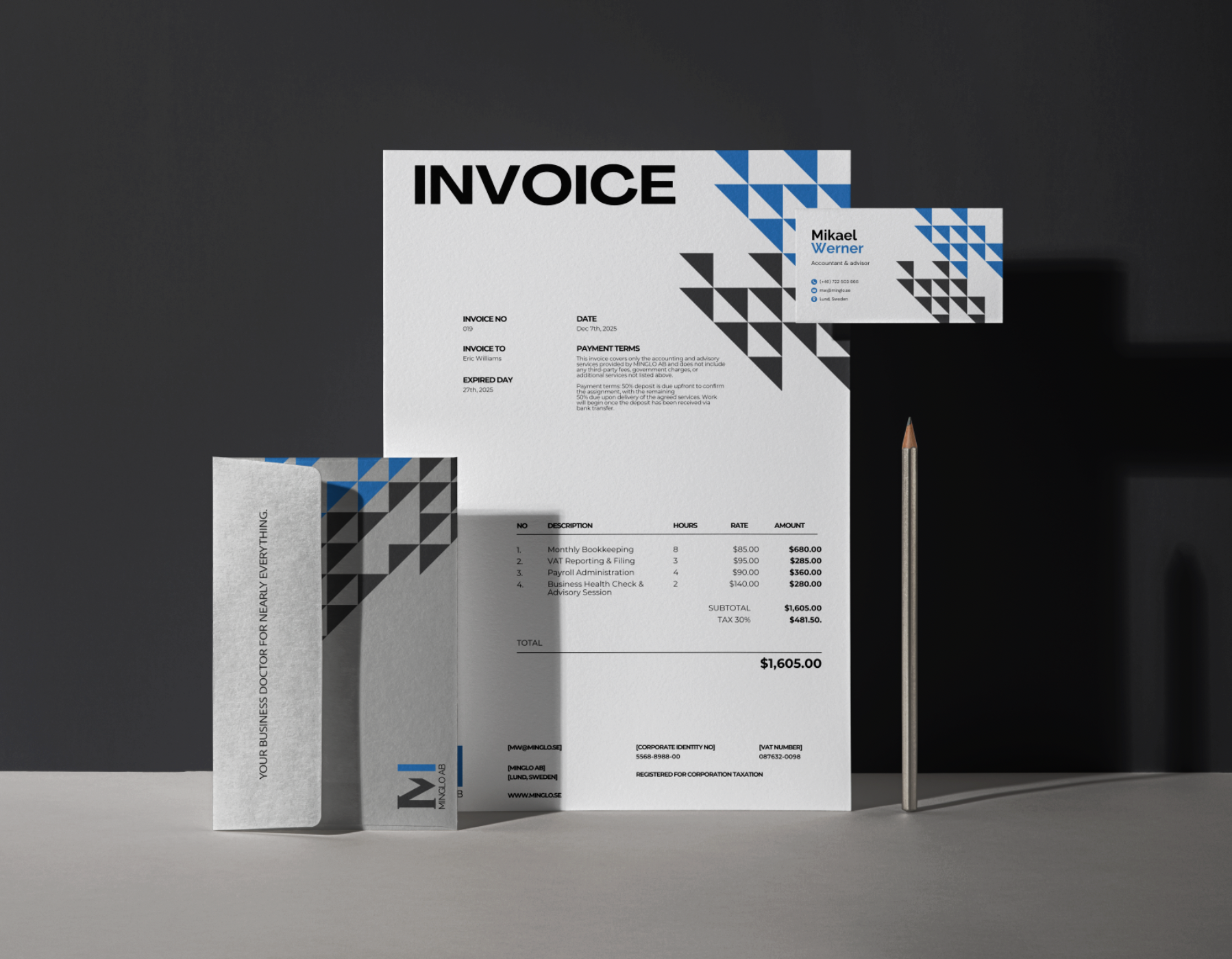 An invoice, a business card, and a pen on a desk. The invoice has a modern design with geometric patterns in black, grey, and blue, and lists various services with prices, totaling $1,605.00.