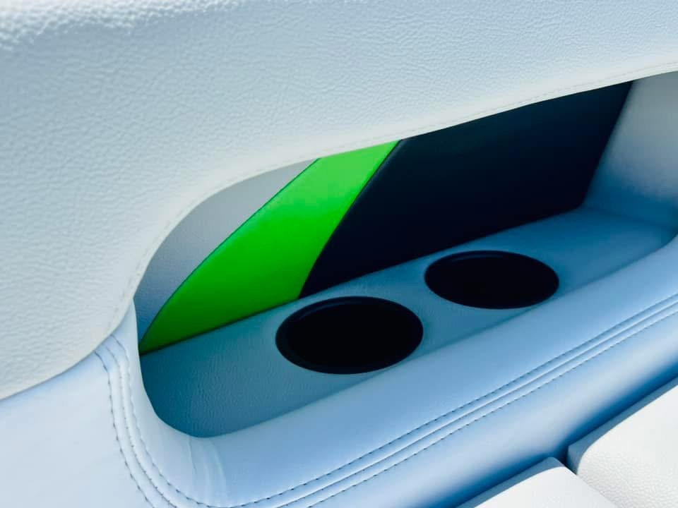 Close-up of the back of a car seat showing built-in cup holders and colorful accent panels.