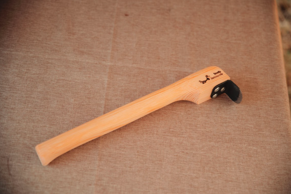 Long-handled dry scraper for hide tanning on linen background