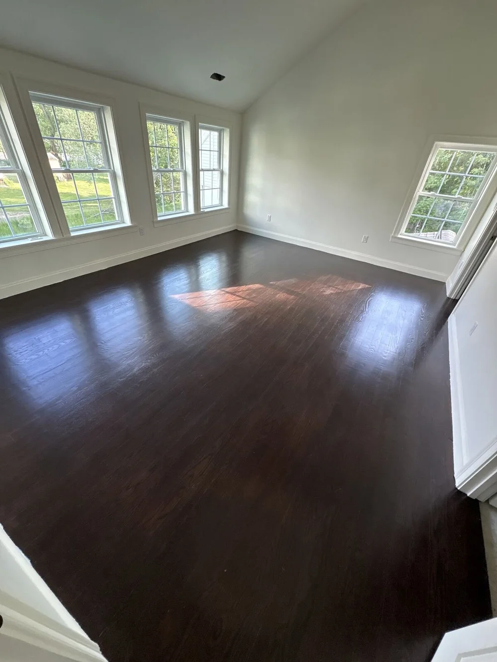 Finished room with clean hardwood floors after a post-construction cleaning in Beverly, MA