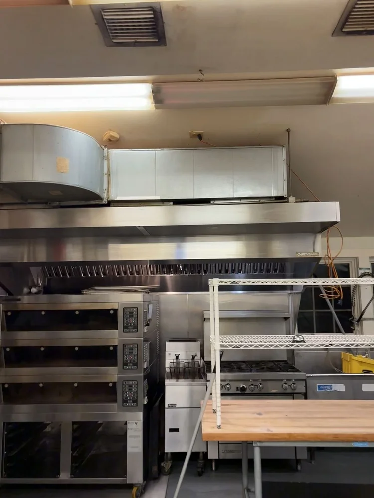 Commercial kitchen with stainless steel equipment after cleaning