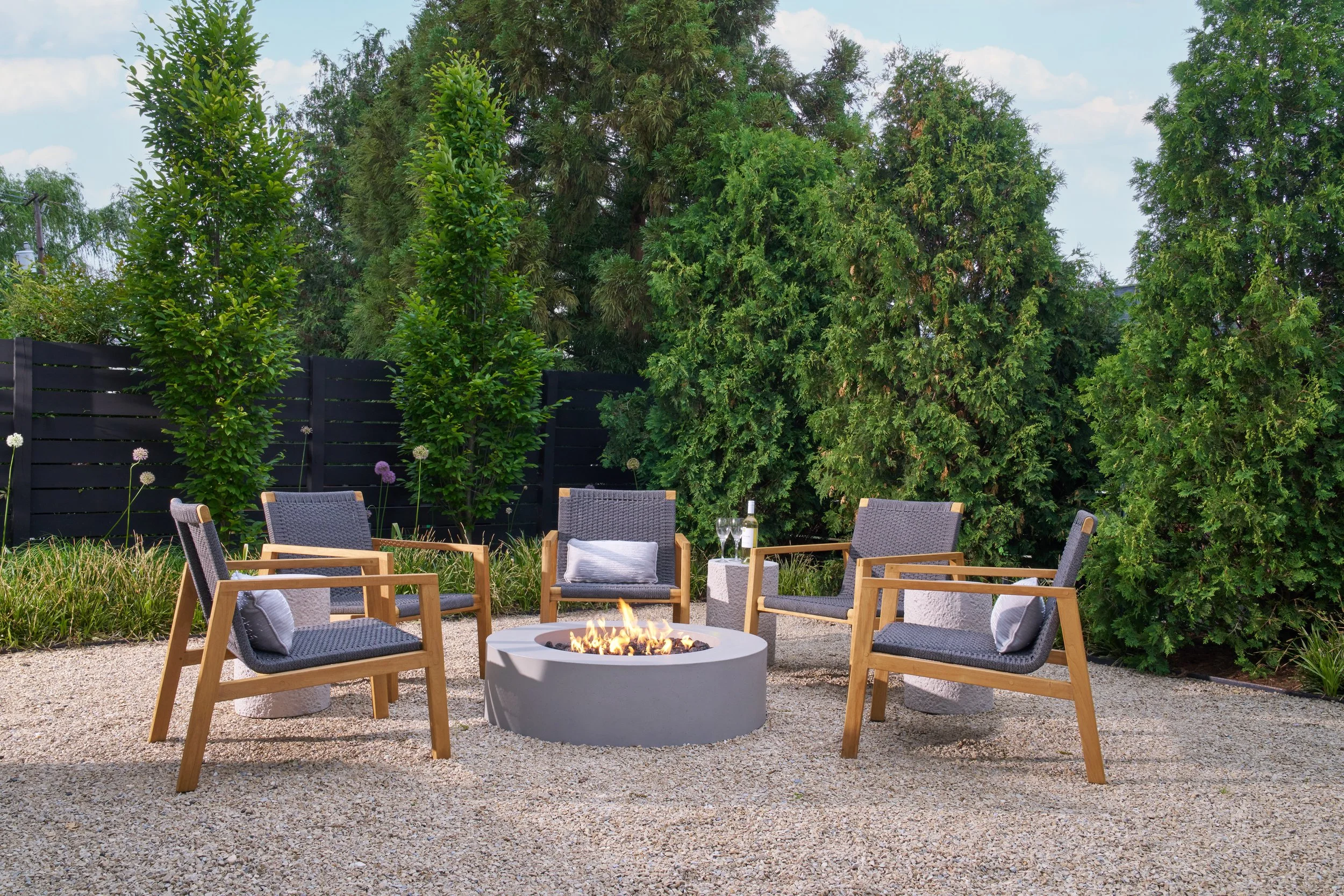 Contemporary outdoor seating area with fire pit and natural  landscaping in an Annapolis residence