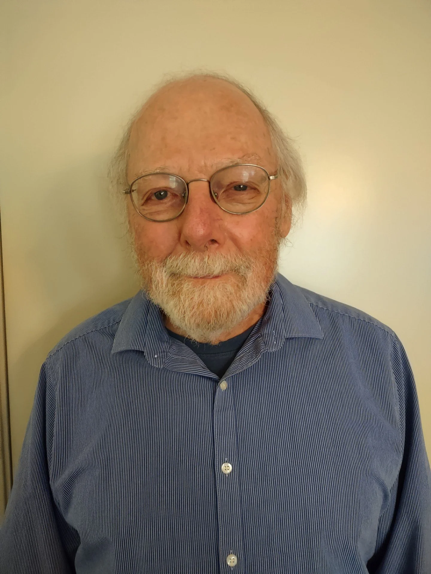 Silhouette of a young man wearing a hoodie and a cap, with a serious expression.