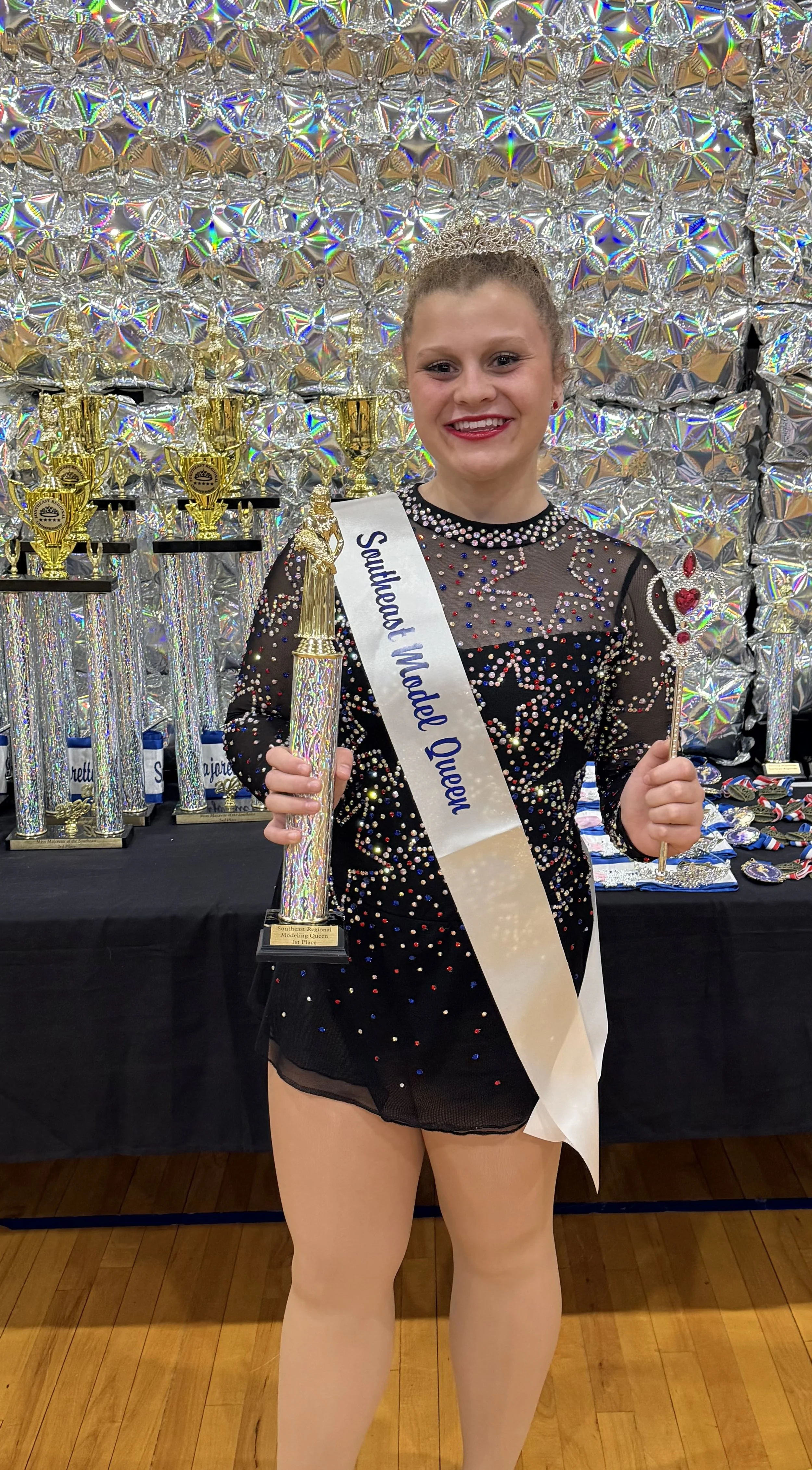 FLARE Baton Team Competitive Twirler posing with her hard earned competition awards from the 2026 Miss Majorette of the Southeast Competition!