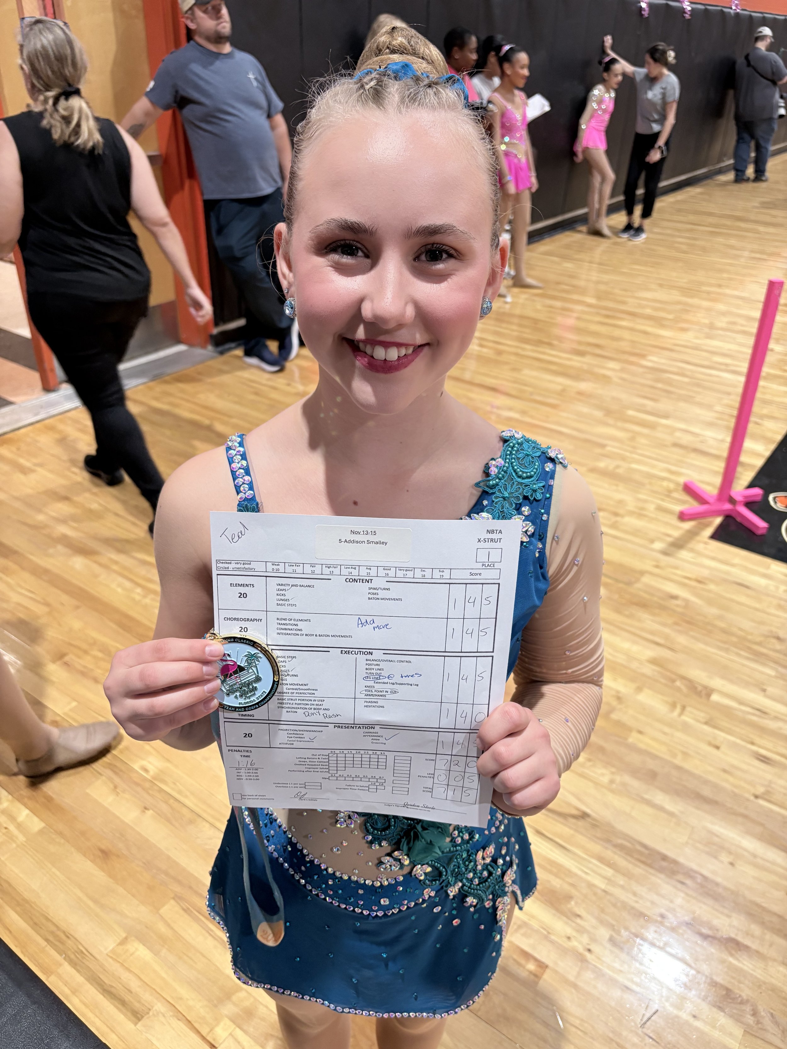 FLARE Baton Team Competitive Twirler posing with her hard earned competition award and score sheet from the 2026 Miss Majorette of Florida Competition!