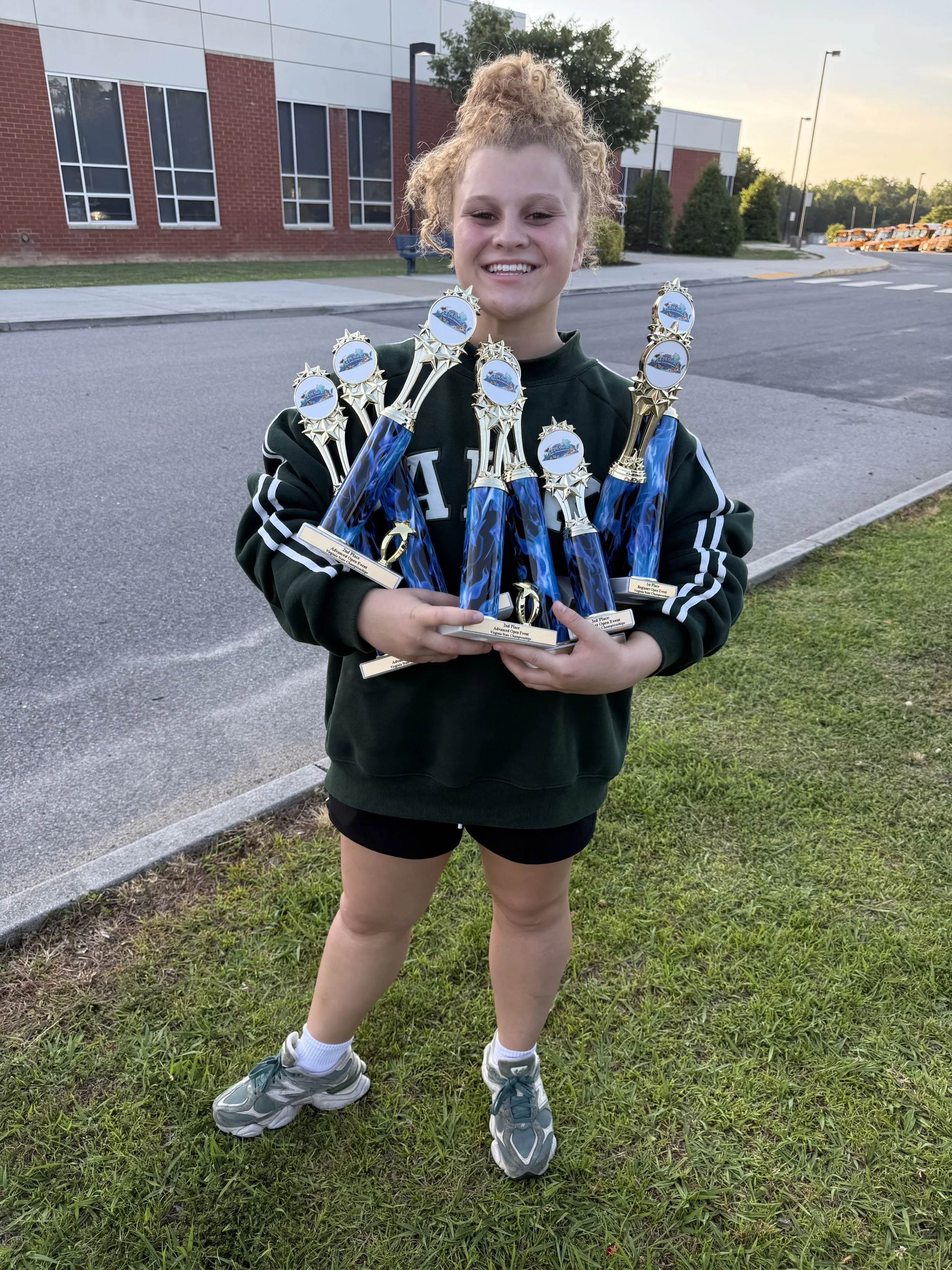 FLARE Baton Team Competitive Twirler posing with her hard earned competition awards from the 2026 Virginia State Baton Twirling Championships!